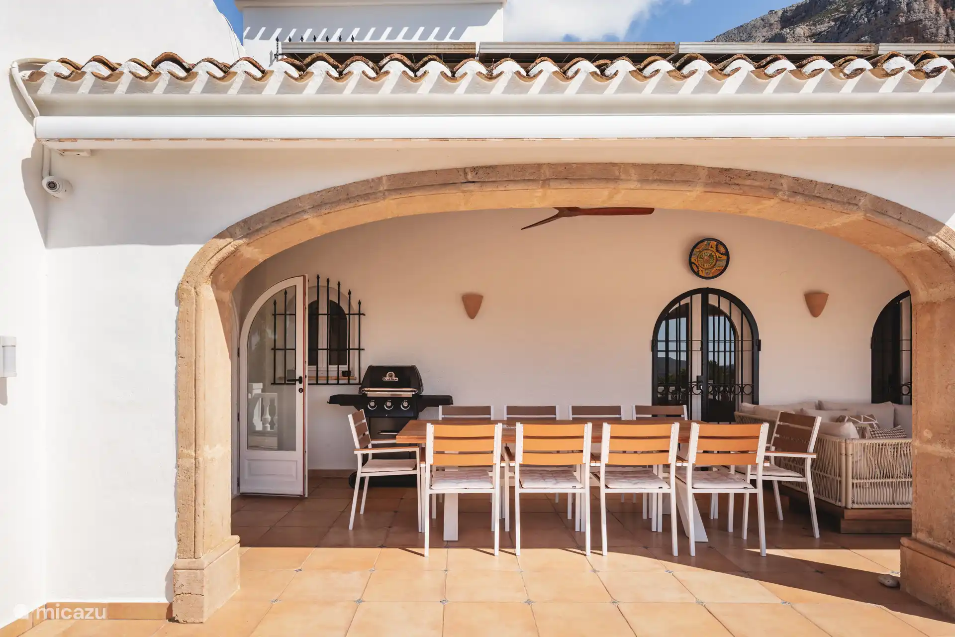 Dining table on terrace with BBQ