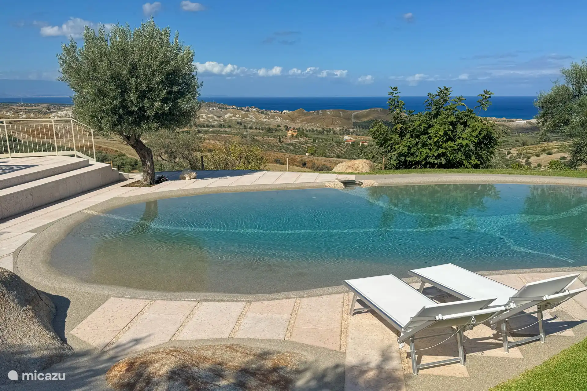 Swimming pool with sunbeds