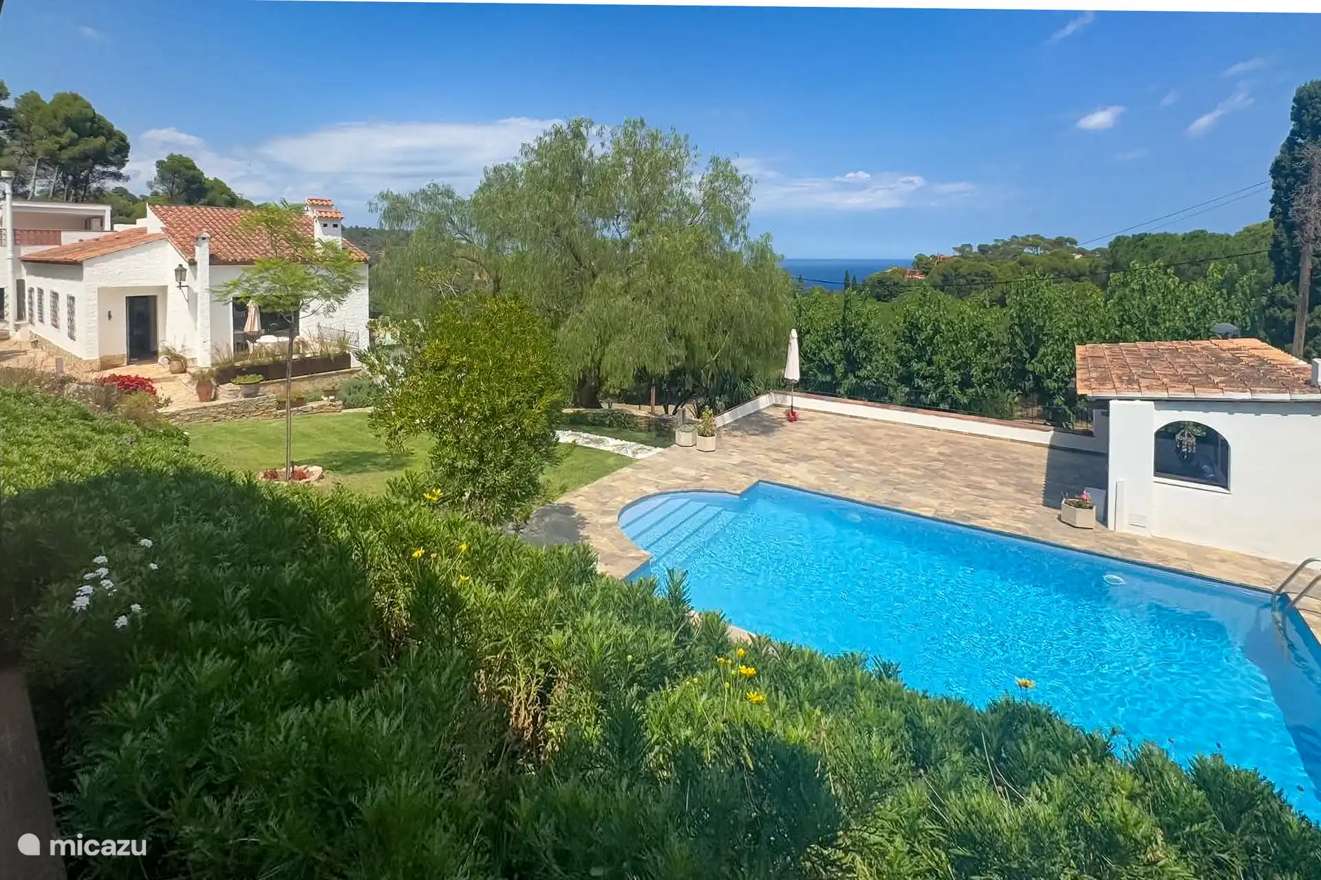 Zwembad, terras en zeezicht. 