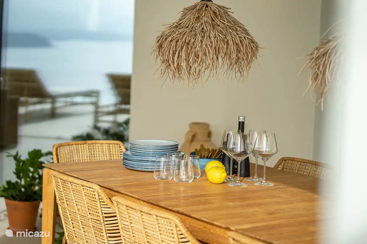 Dining area under the covered terrace with panoramic sea views.