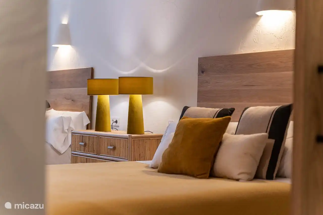 Ground floor bedroom, air conditioning, wardrobes. En-suite bathroom with shower, double sink, hairdryer, towels, products. French doors to the entrance of the villa.