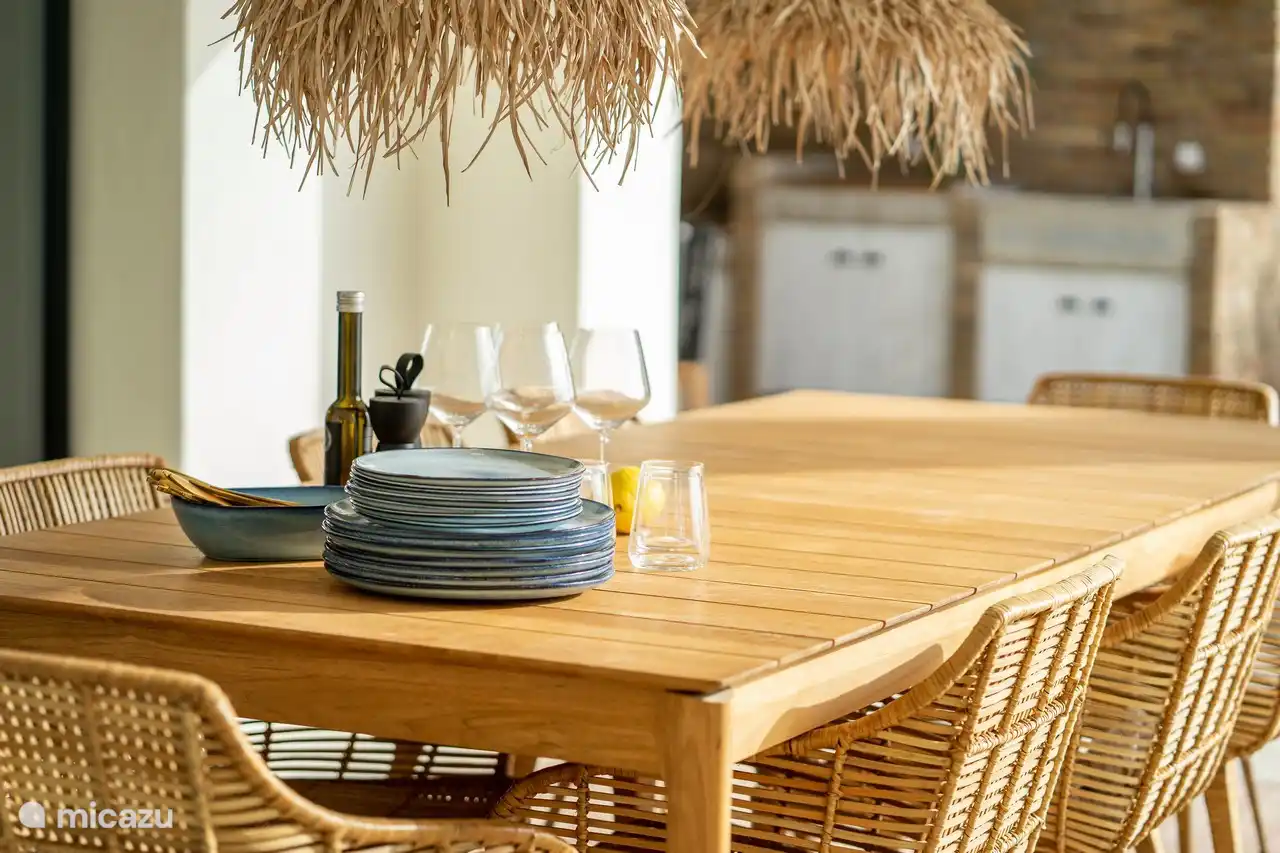 Dining area under the covered terrace with panoramic sea views.