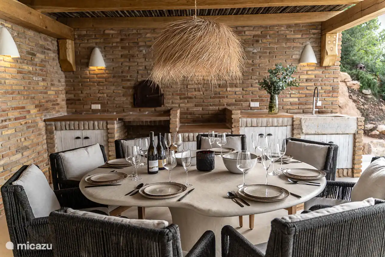 Dining area under the covered terrace, barbecue, panoramic sea views.