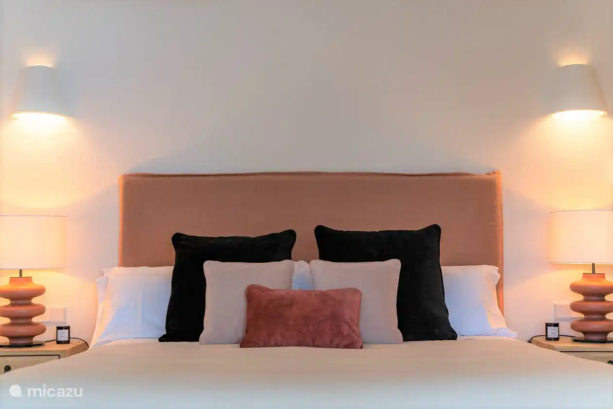 Lower floor bedroom, air conditioning, wardrobes. En-suite bathroom with shower, double sink, hairdryer, towels, products. French doors to a terrace with sea views.