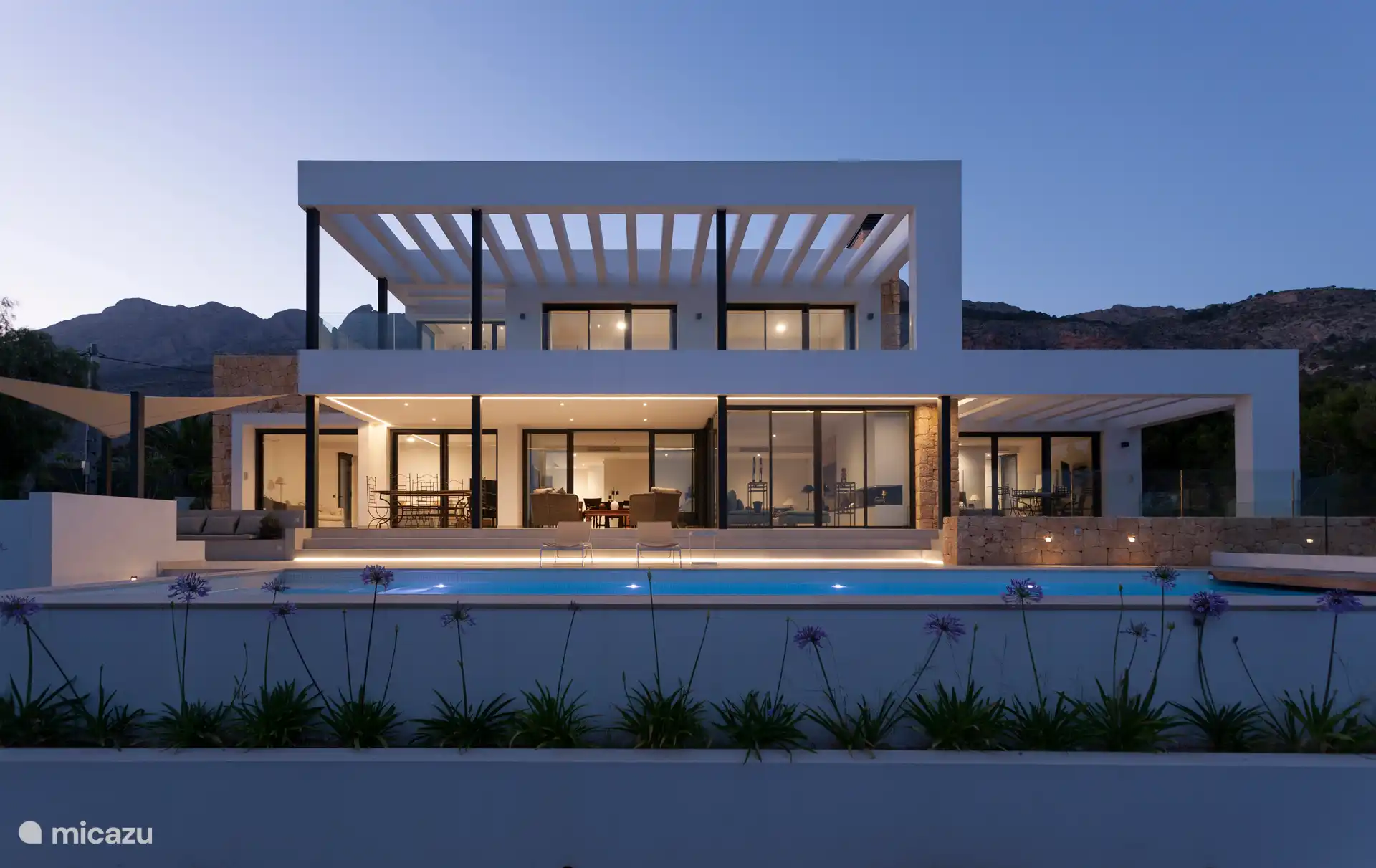 Swimming pool surrounded by a terrace with sun loungers and a garden, sea view, chillout area, small lounge, dining table, gas barbecue.