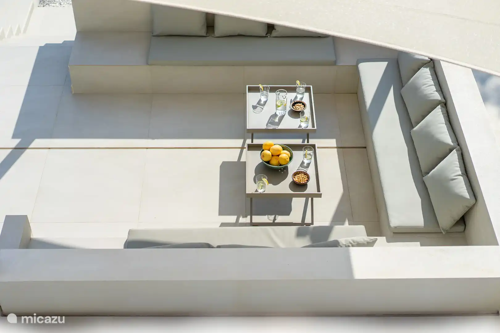 Swimming pool surrounded by a terrace with sun loungers and a garden, sea view, chillout area.