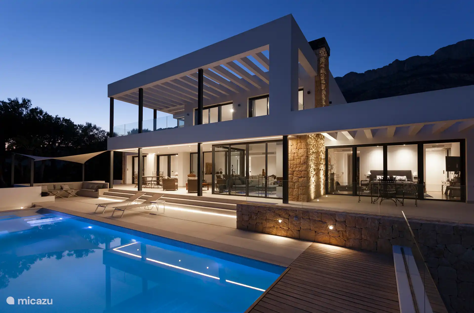 Swimming pool surrounded by a terrace with sun loungers and a garden, sea view, chillout area, small lounge, dining table, gas barbecue.