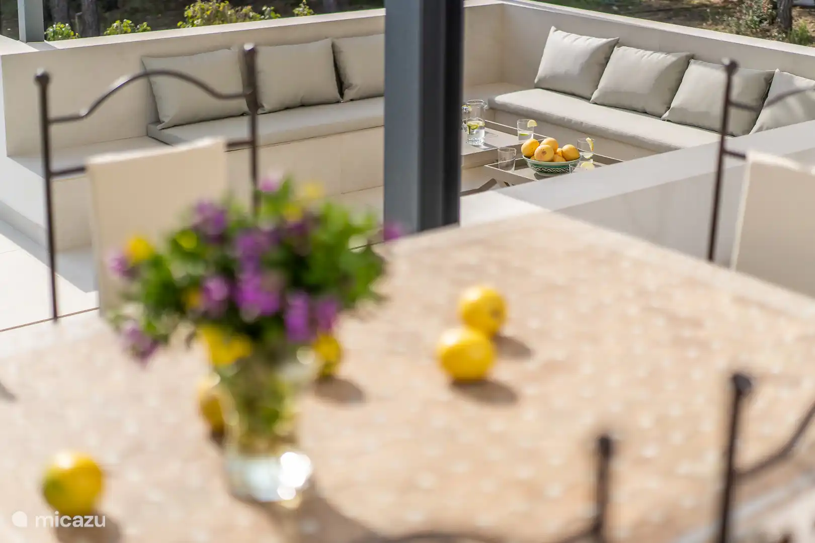 Swimming pool surrounded by a terrace with sun loungers and a garden, sea view, dining table, chillout area.