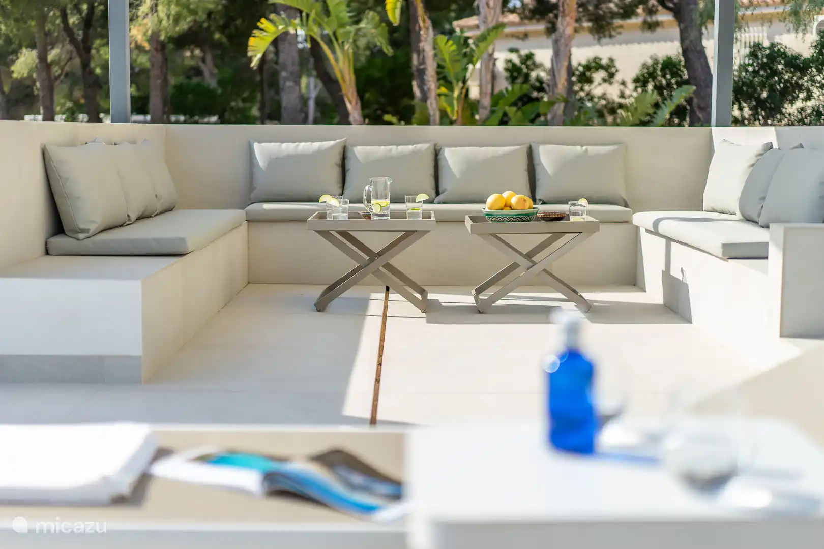 Swimming pool surrounded by a terrace with sun loungers and a garden, sea view, dining table, chillout area.