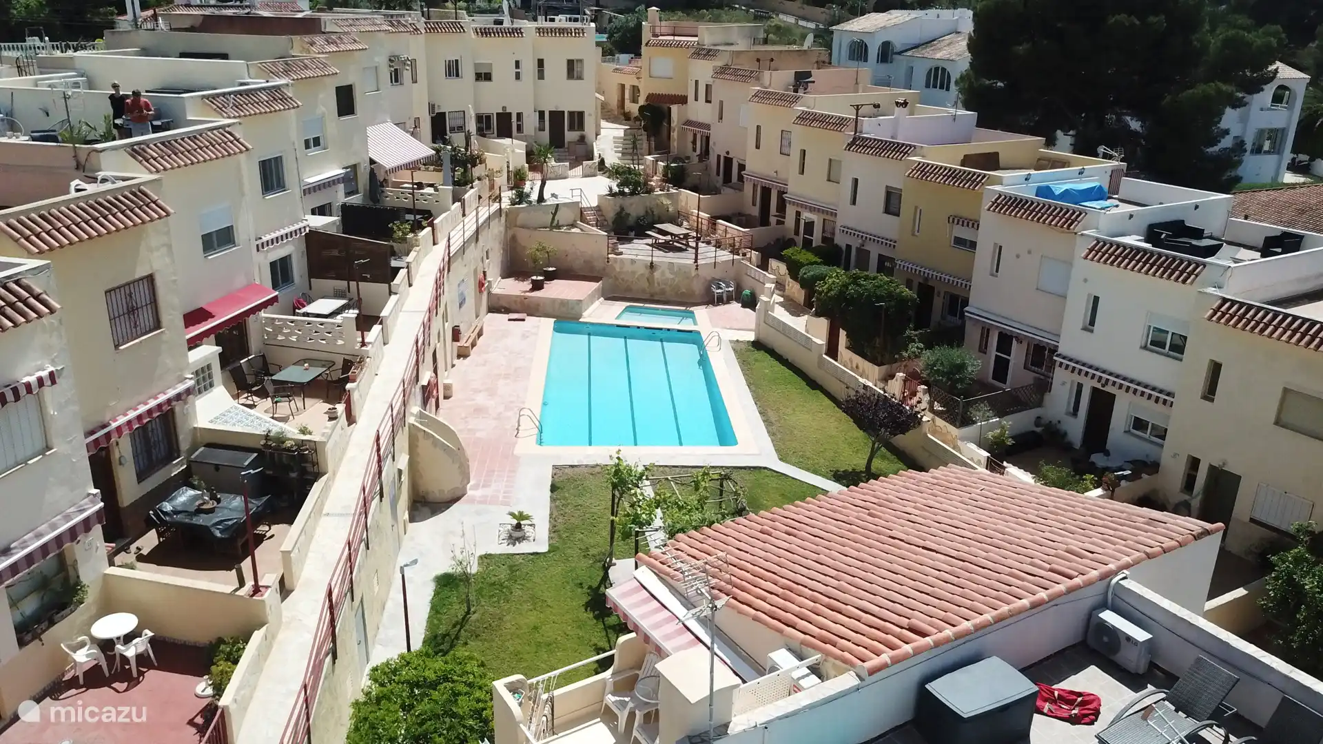 The community consists of semi-detached houses around the courtyard garden with swimming pool
