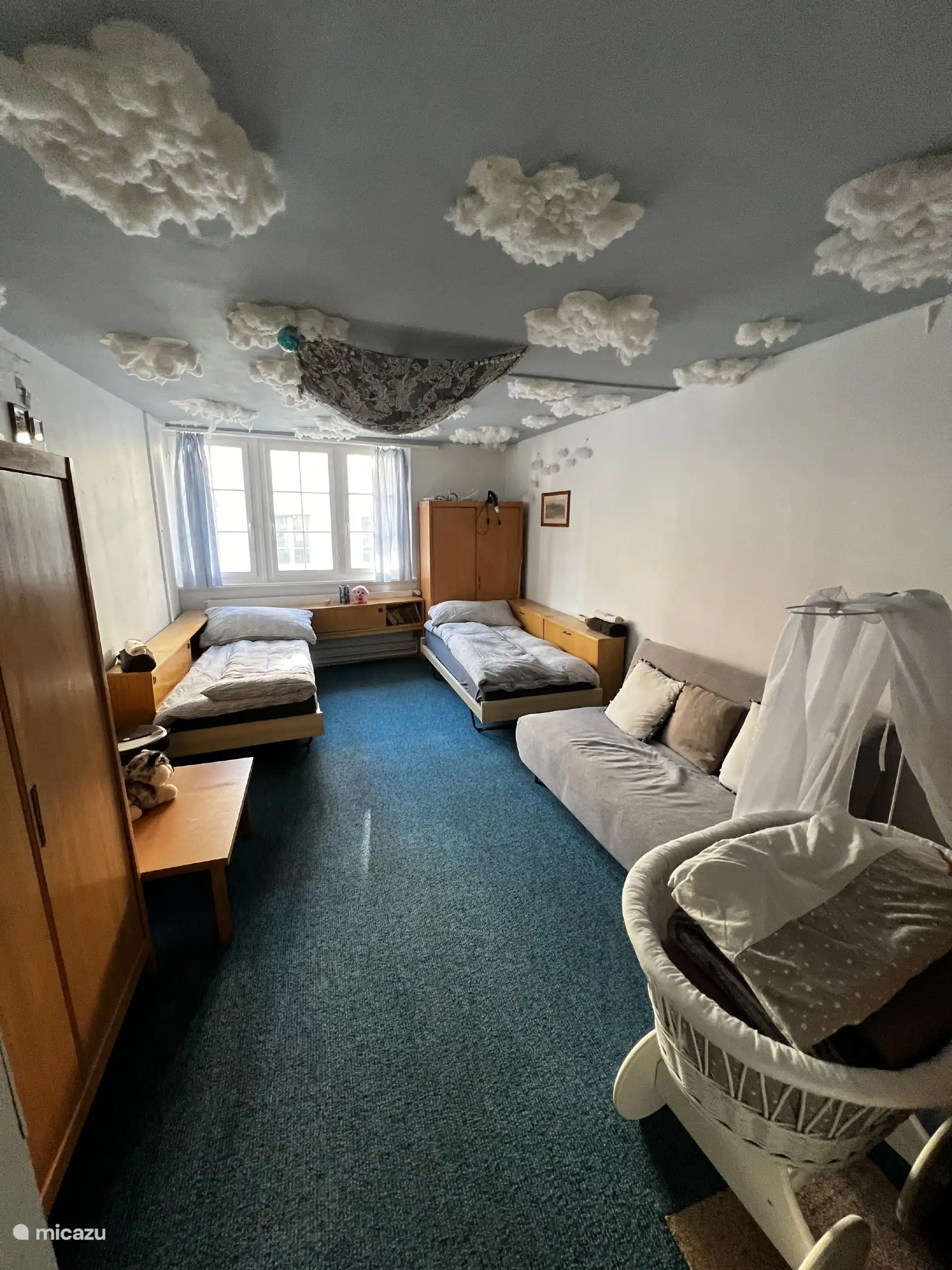 Kamer met twee eenpersoonsbedden en één slaapbank.