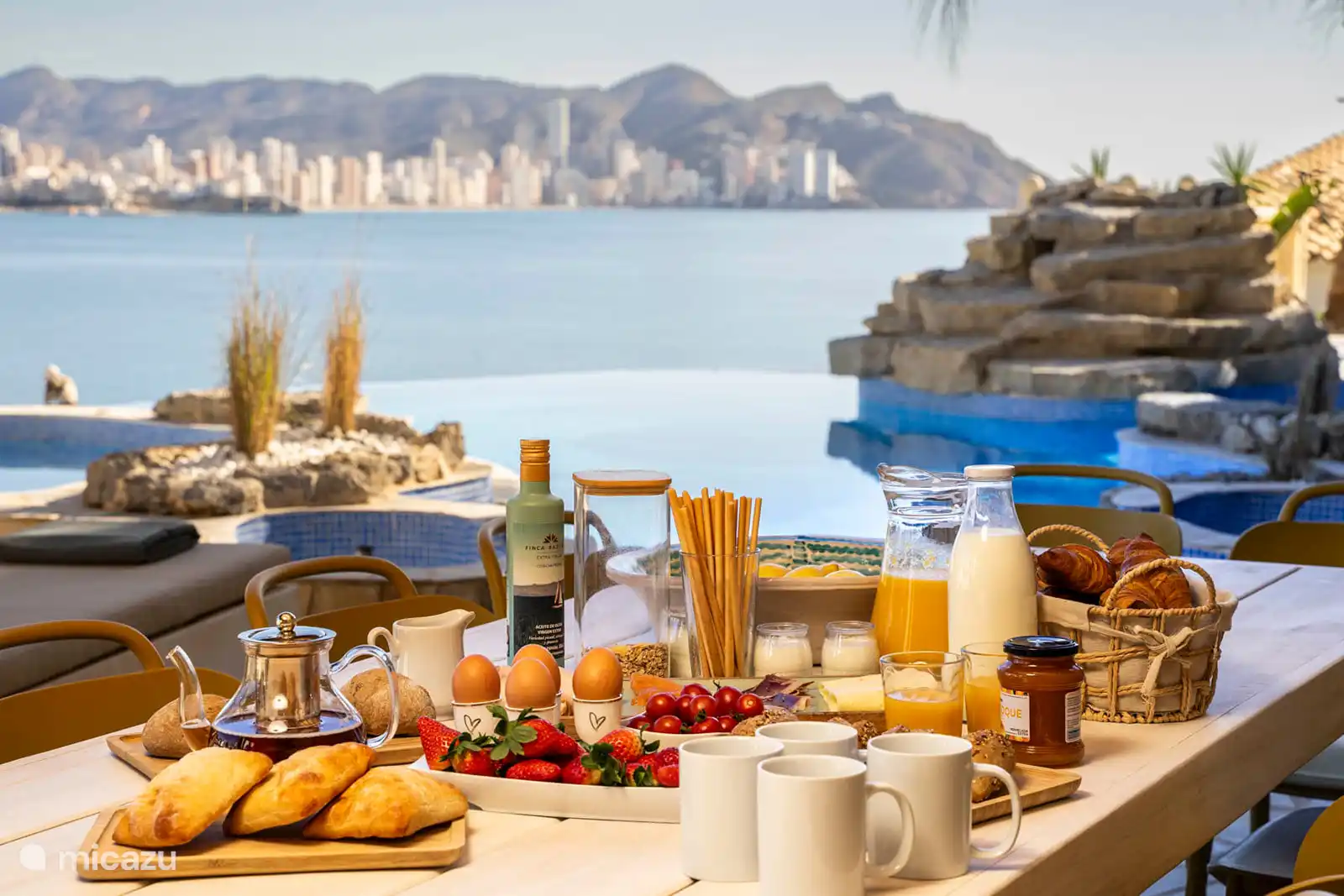 Breakfast by the pool with sea view.