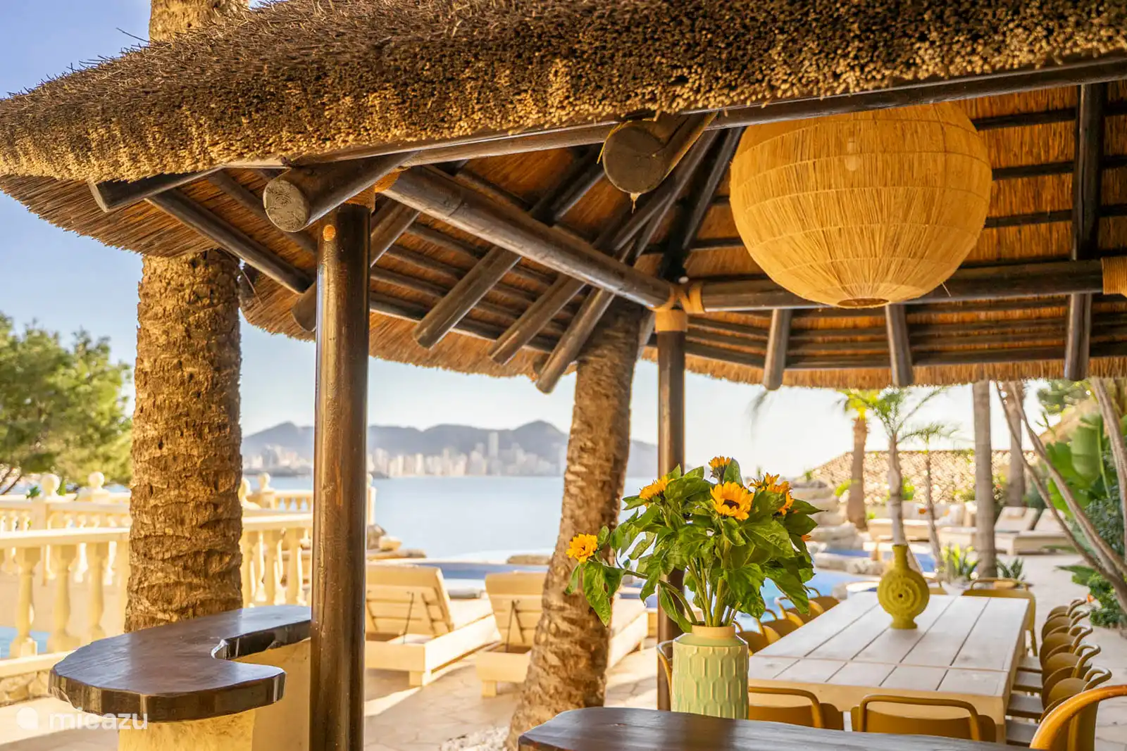 Infinity pool, jacuzzi, paddling pool, fountain, surrounded by a terrace with sun loungers, sofas. Dining room, Barbecue, sea view.