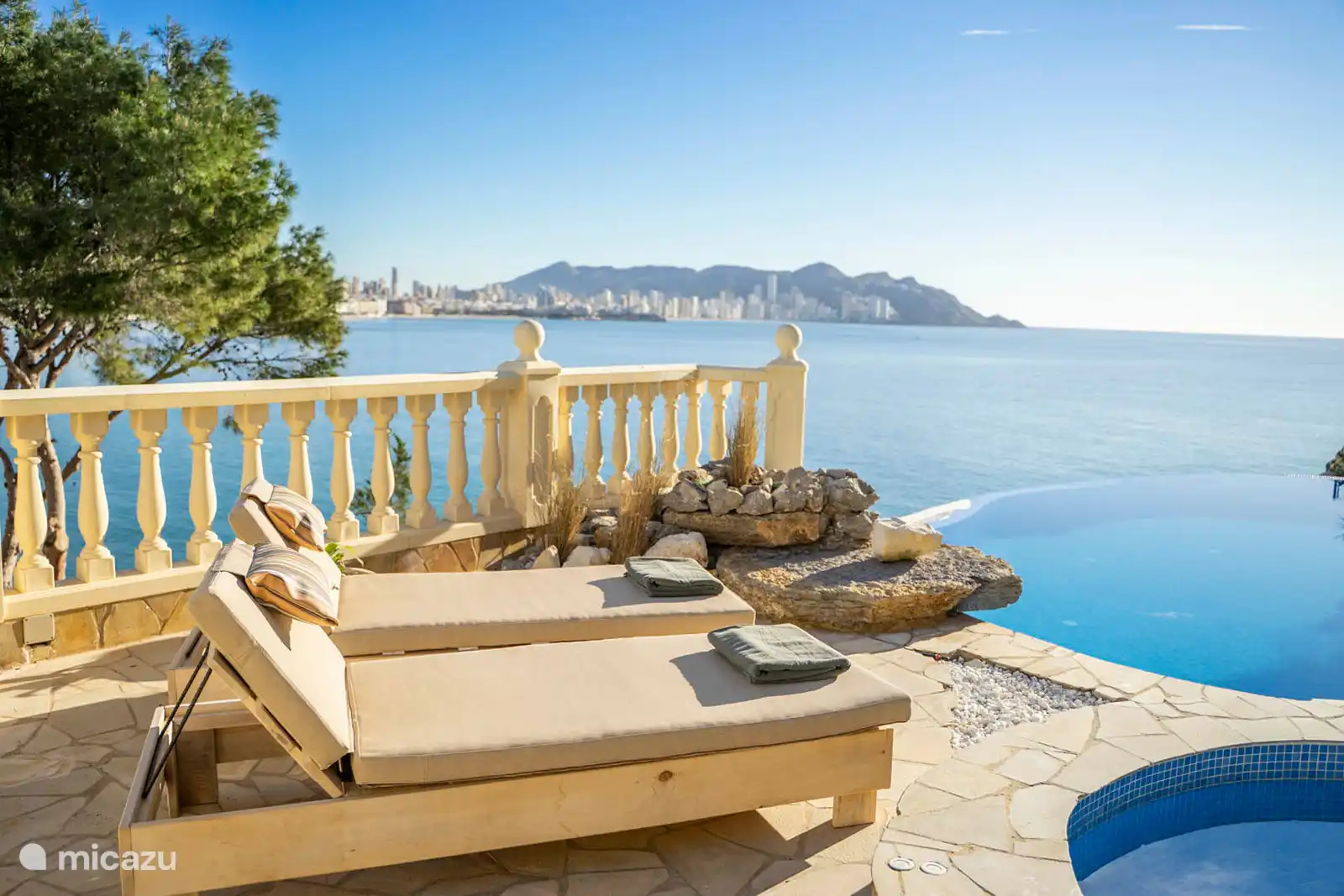 Infinity-Pool, Jacuzzi, Planschbecken, Brunnen, umgeben von einer Terrasse mit Liegeliege, Sofas. Speisesaal, Grill, Meerblick.