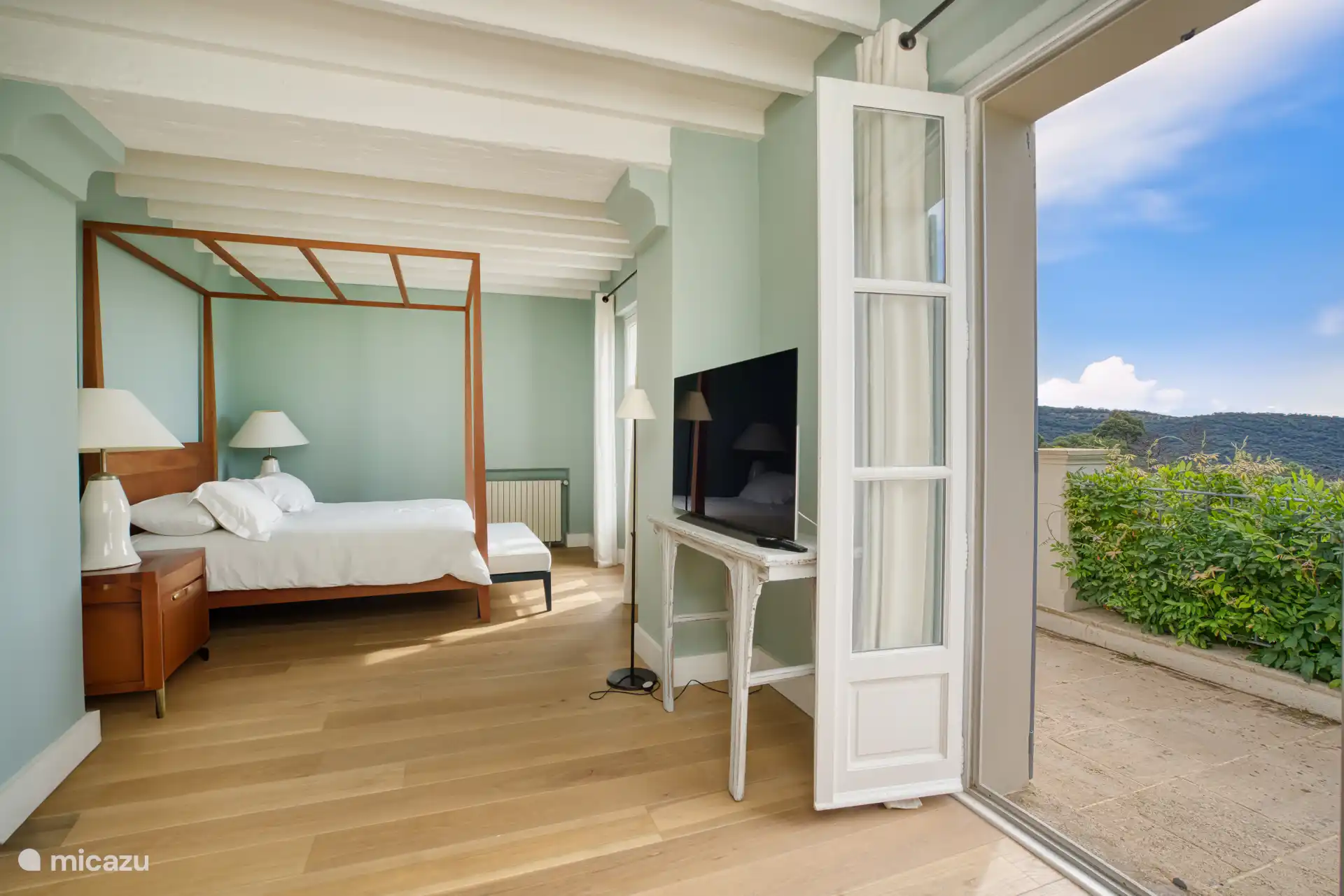 Main bedroom with A/C, TV, balcony