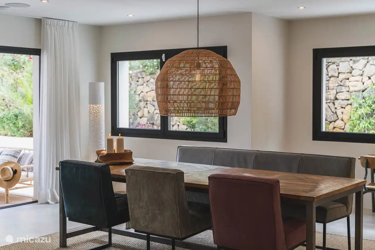 Salle à manger avec une grande table, des sièges et une banquette confortable pour passer du bon temps.