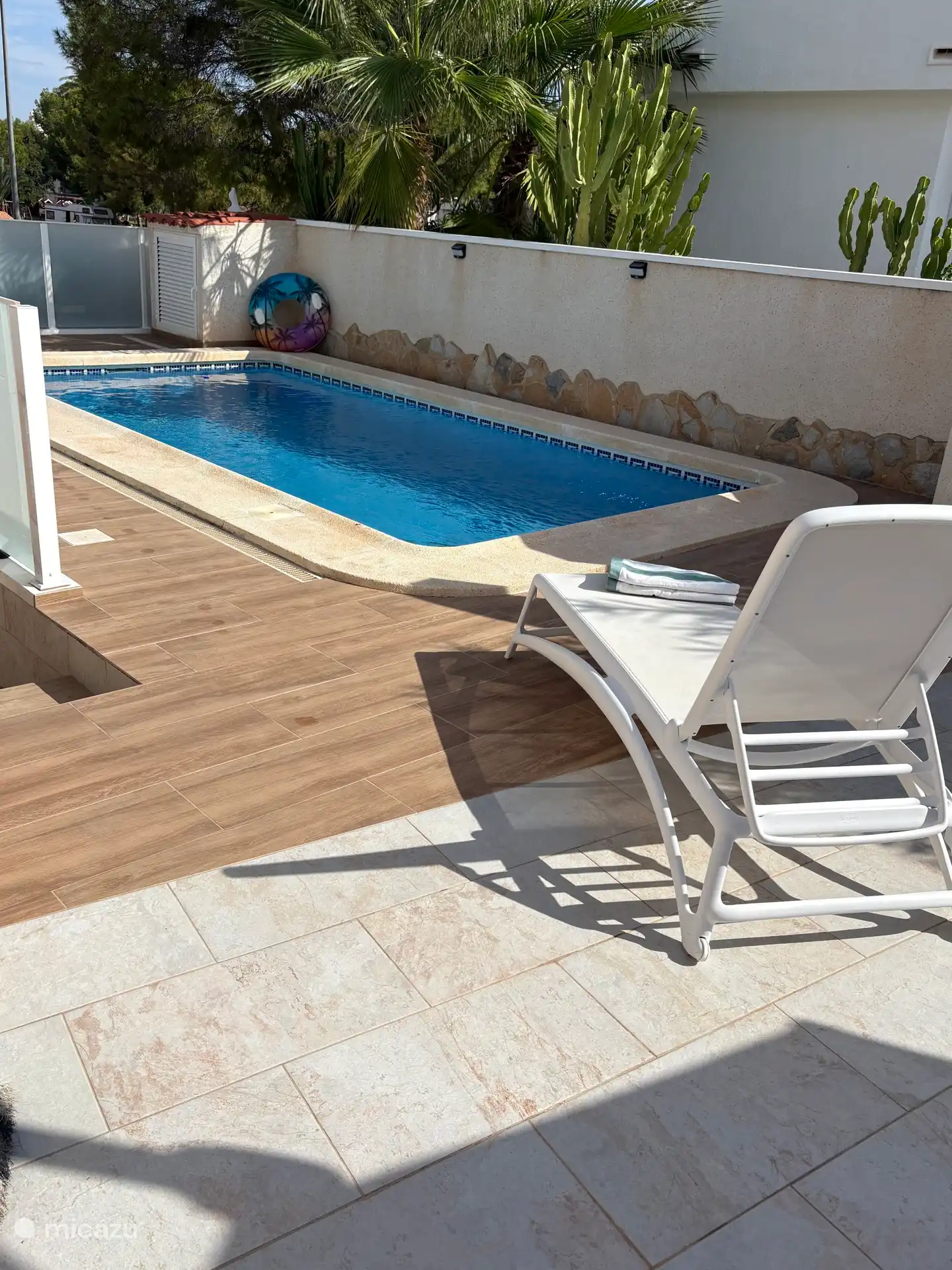 Swimming pool with sun lounger