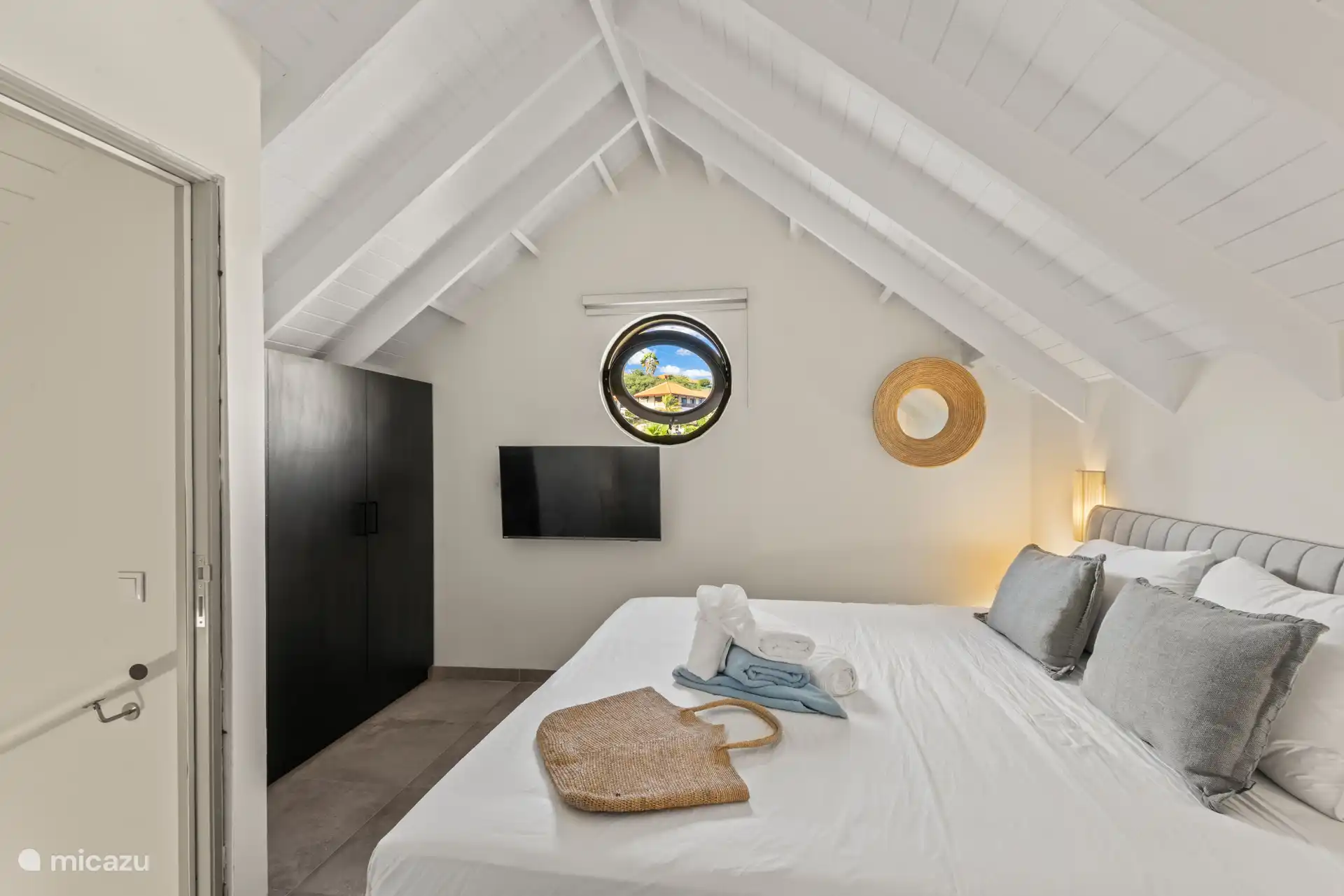 Bedroom 3 on the first floor with double bed, private bathroom, TV, wardrobe and a/c.