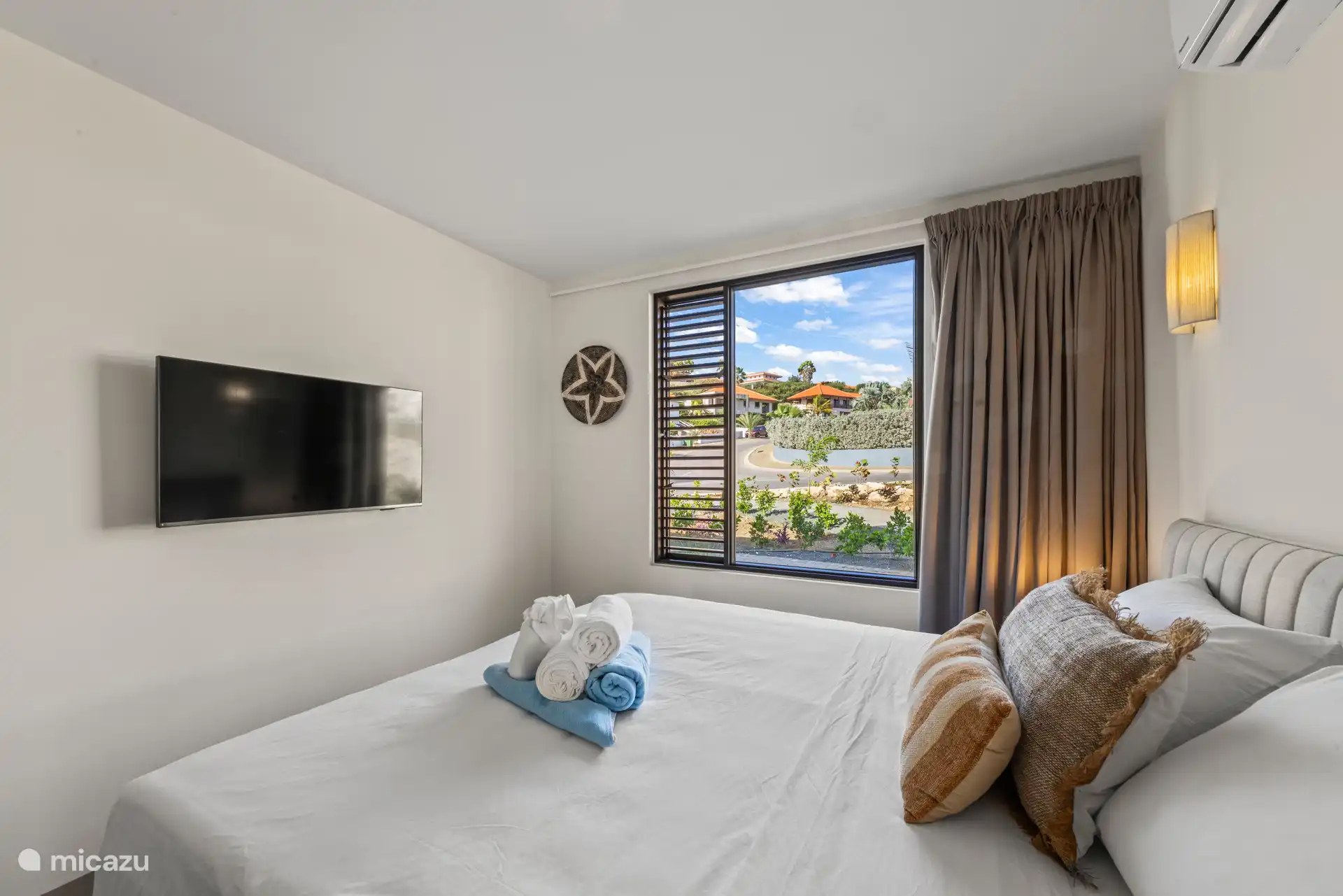 Bedroom 2 with double bed, private bathroom, TV, wardrobe and a/c.