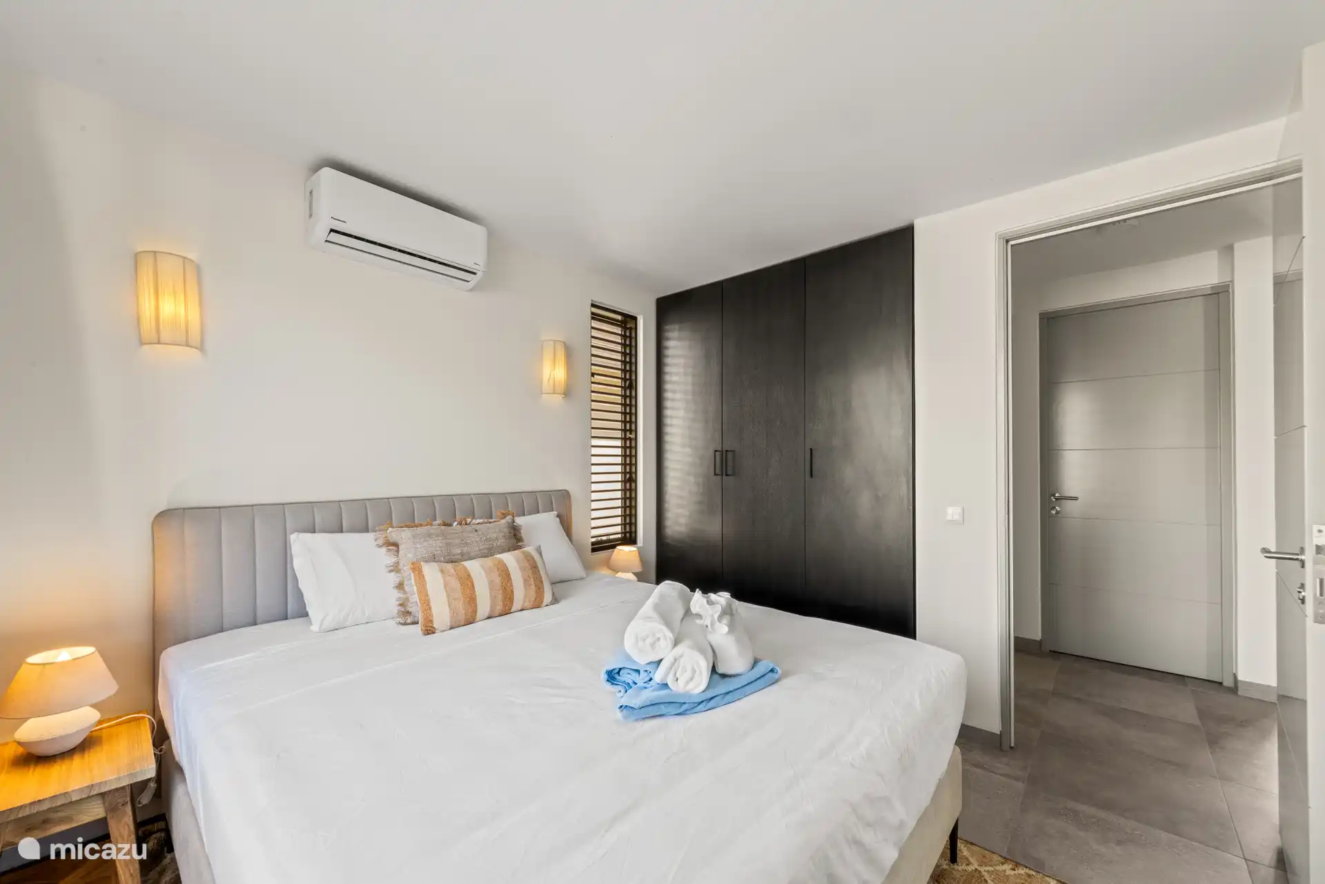 Bedroom 2 with double bed, private bathroom, TV, wardrobe and a/c.