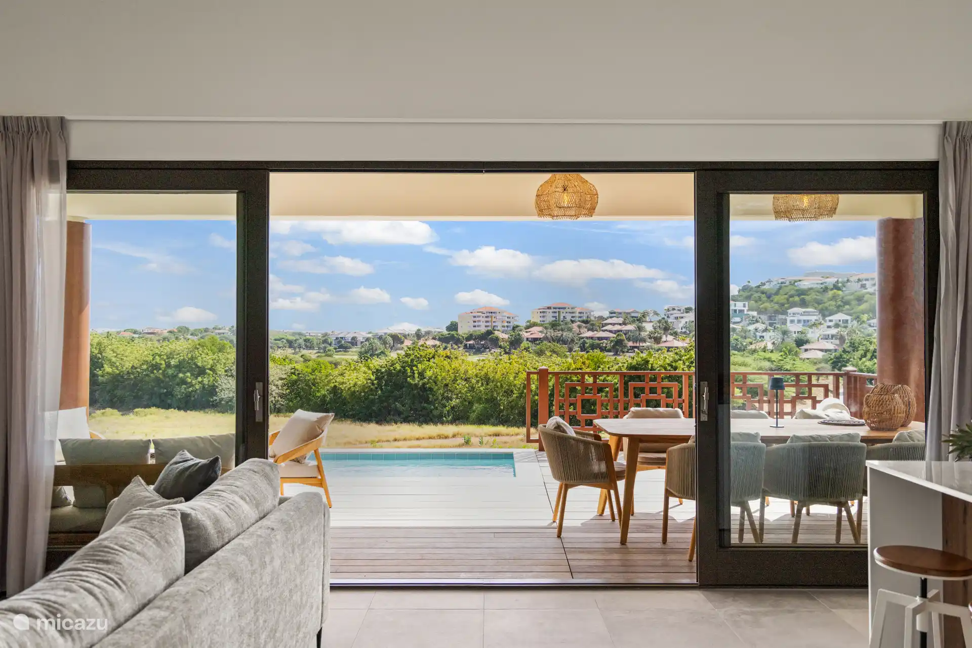 Large sliding doors blur the line between indoor and outdoor living, inviting the tropical breeze in.