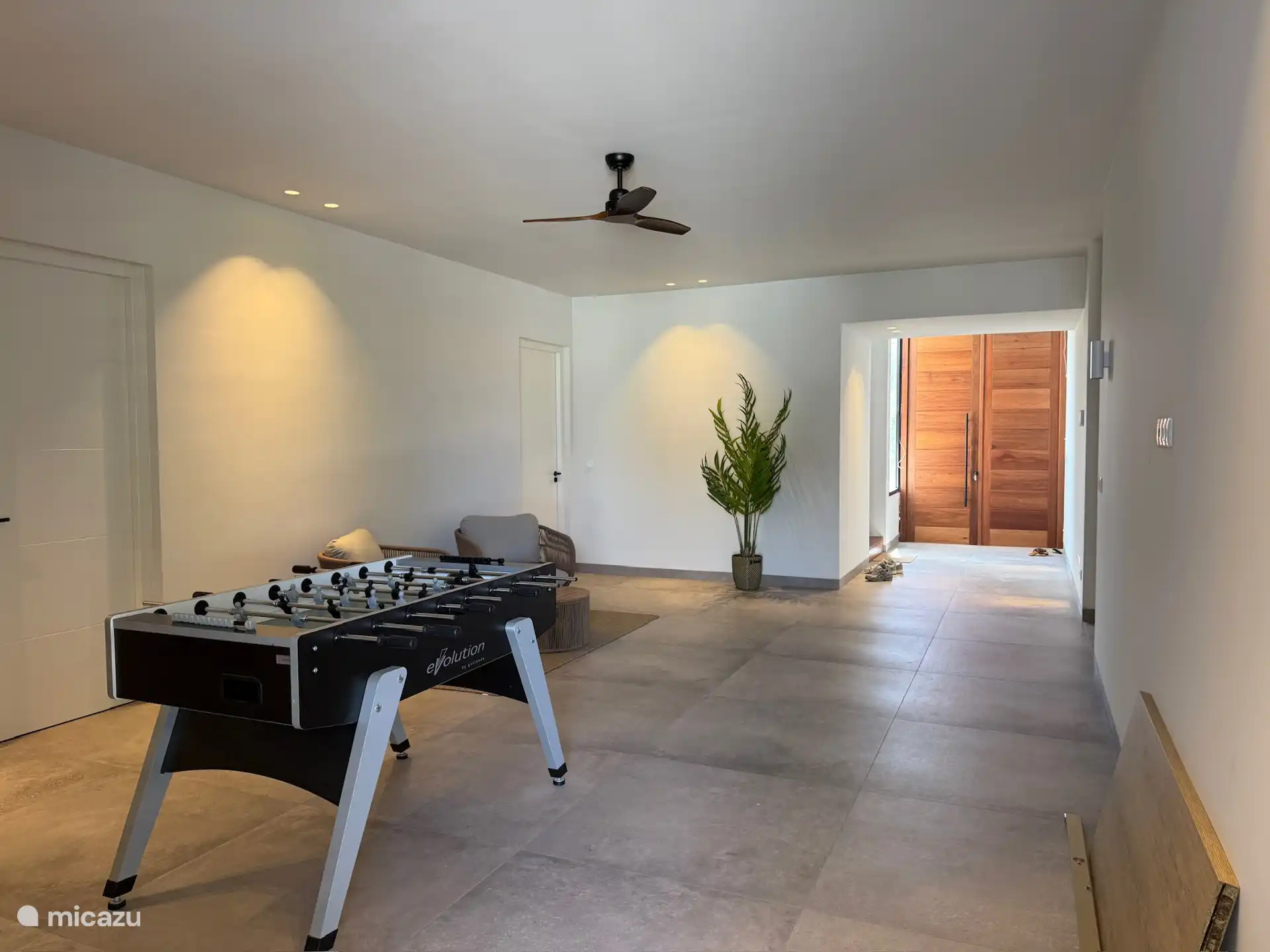 Salón central con asientos y mesa de fútbol