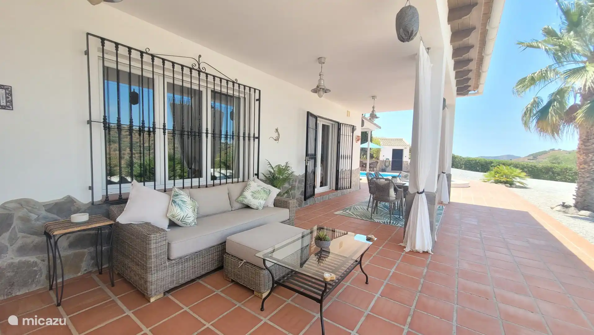 Covered terrace with lounge area and dining table