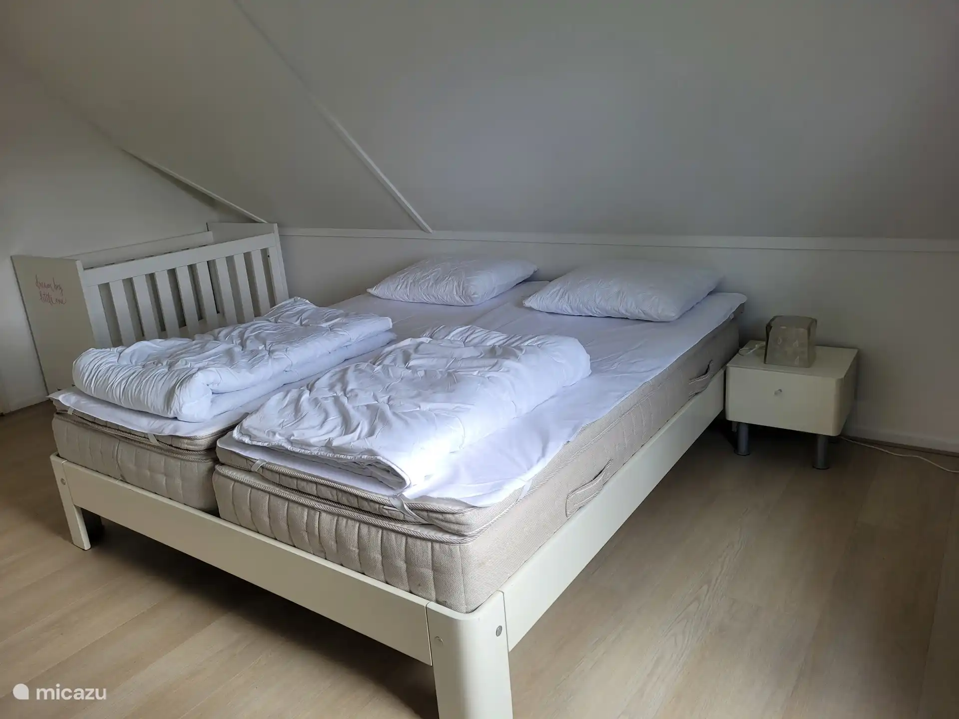 Bedroom with double bed, chest of drawers and cot