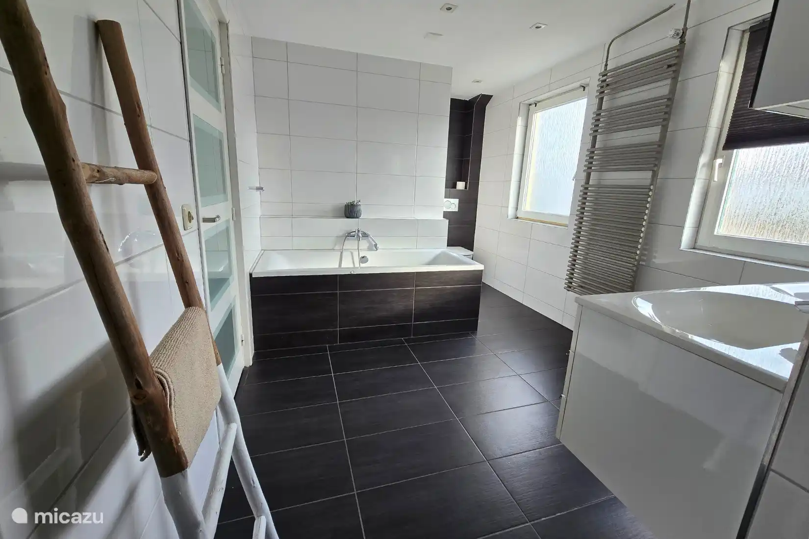 Spacious bathroom with shower, bath and toilet
