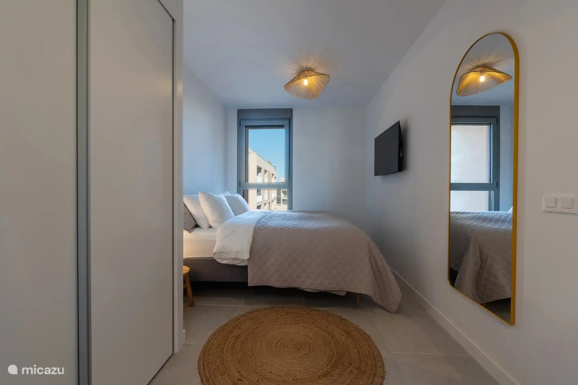 Bedroom with double bed. Built-in wardrobe with hang and lie and safe. 