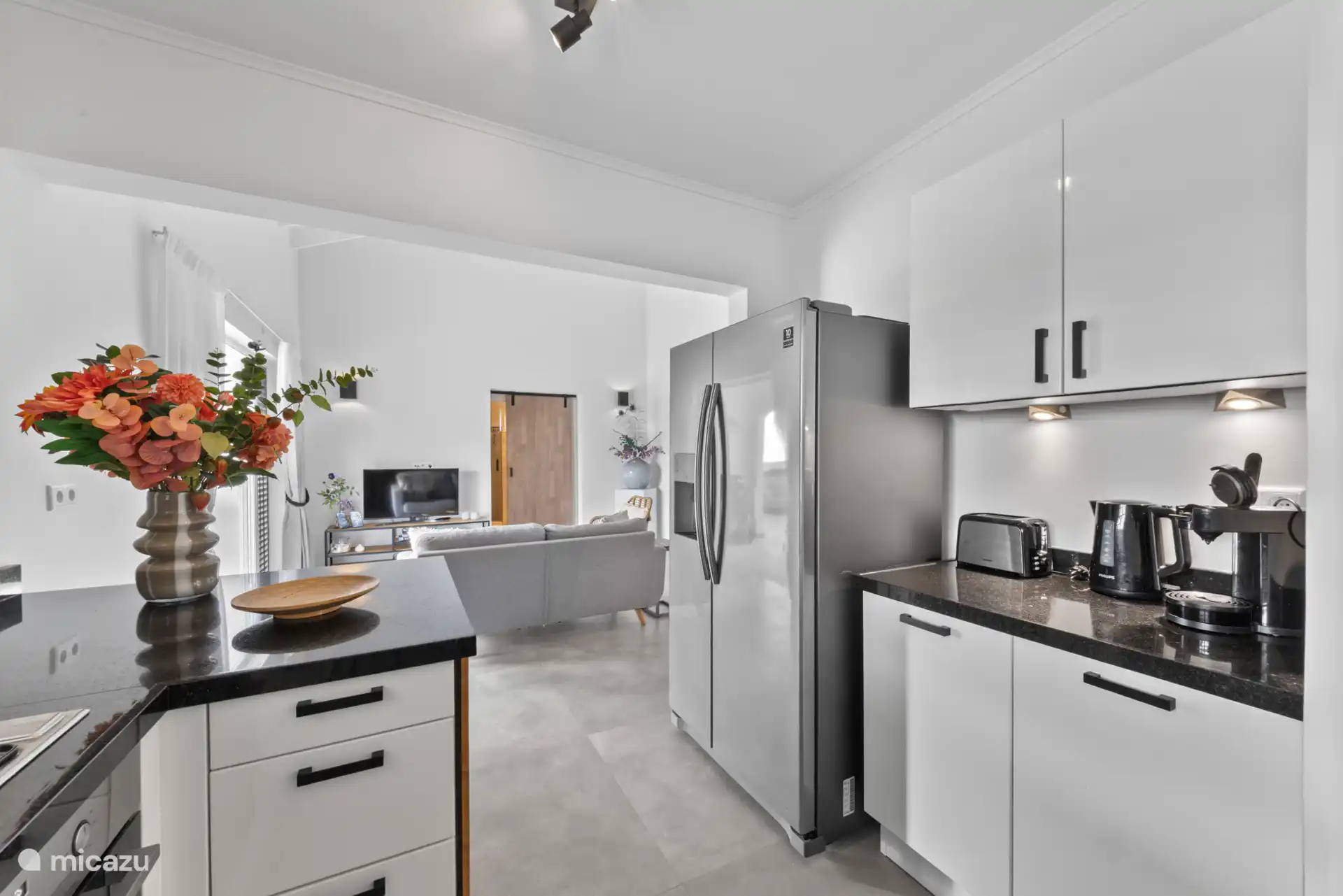 Zicht vanuit de open keuken op de woonkamer. 