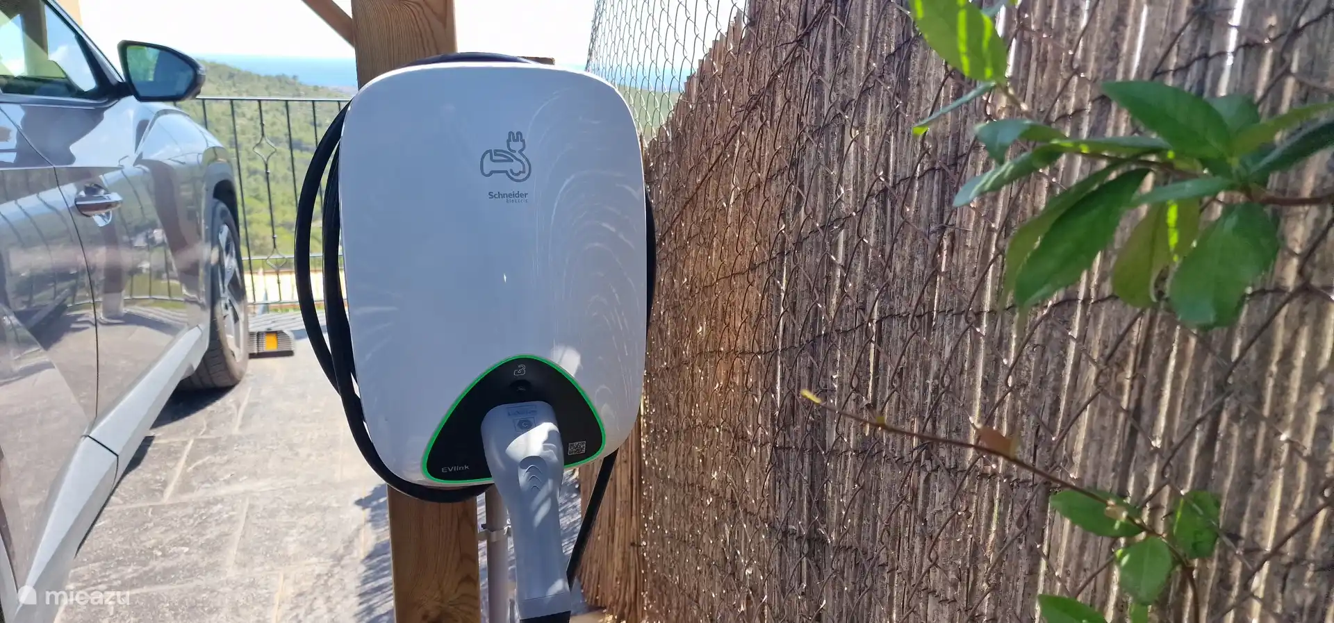 Oplaadpaal parkeerplaats binnen automatische poort.