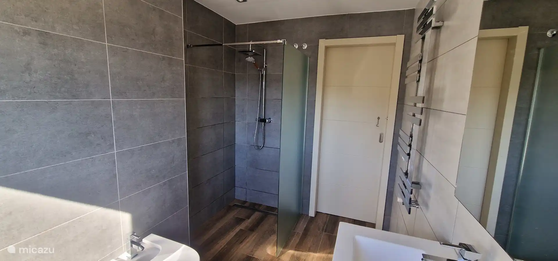 Grijze badkamer tussen de twee slaapkamers, gevestigd op de begane grond.