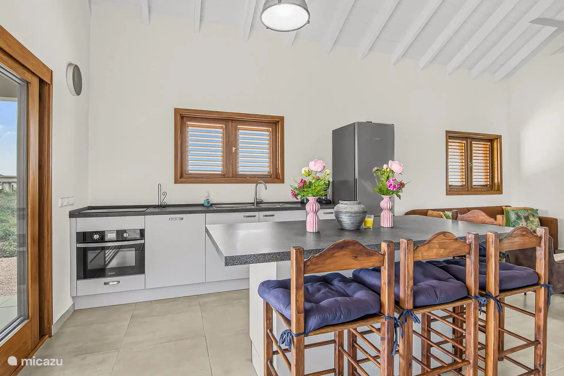 Spacious kitchen with plenty of seating, dishwasher, combi oven and induction hob.