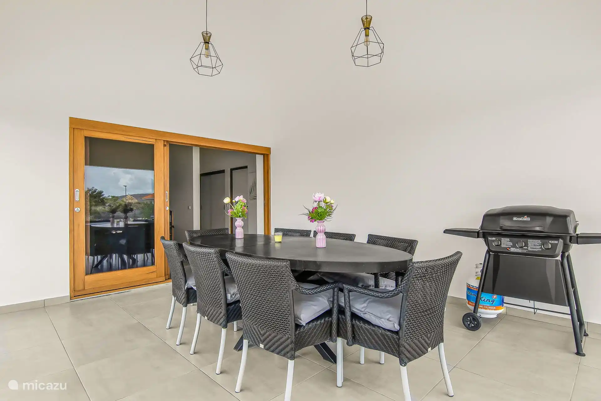 Large outdoor dining table with 8 chairs and gas bbq