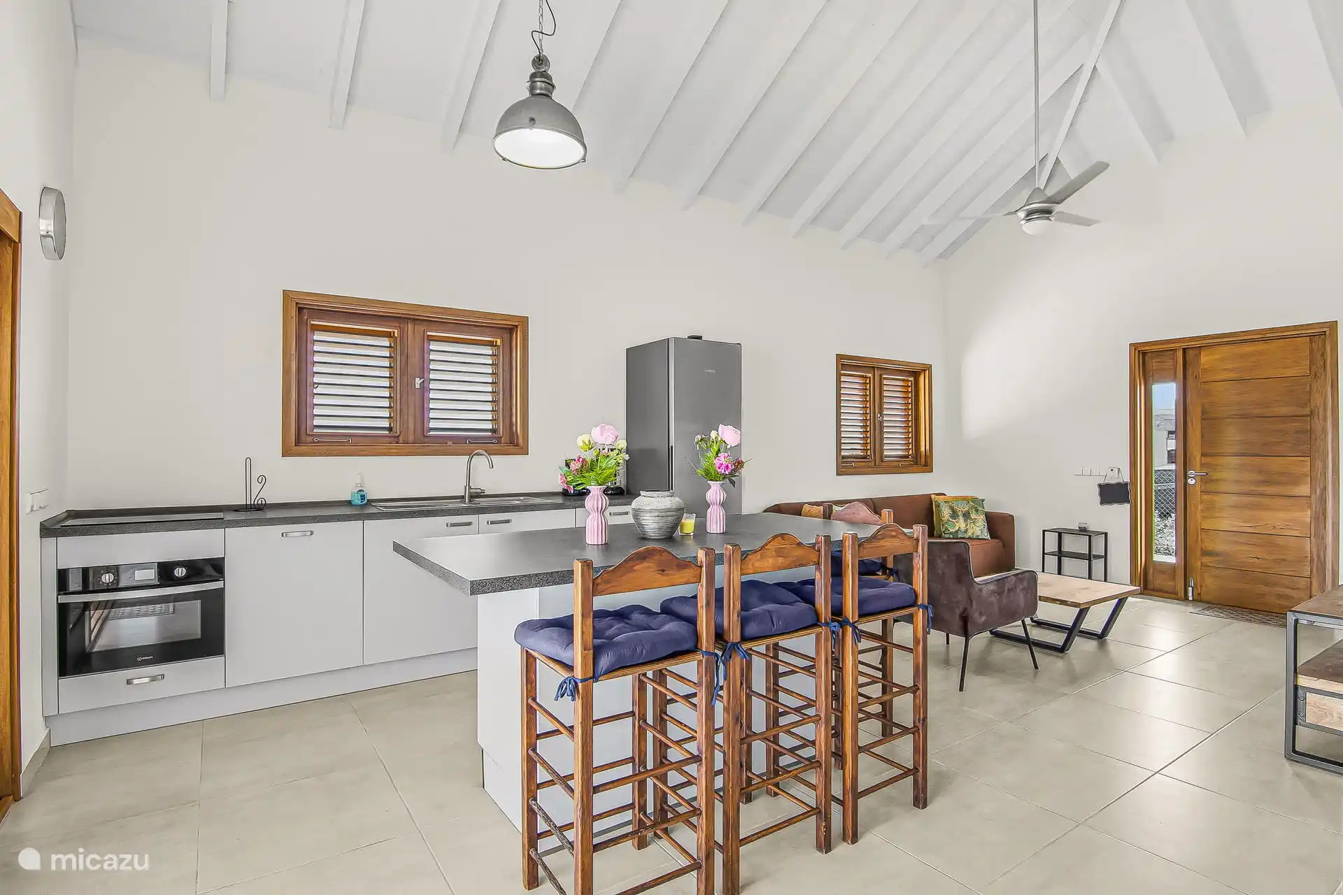 Spacious kitchen with plenty of seating, dishwasher, combi oven and induction hob.