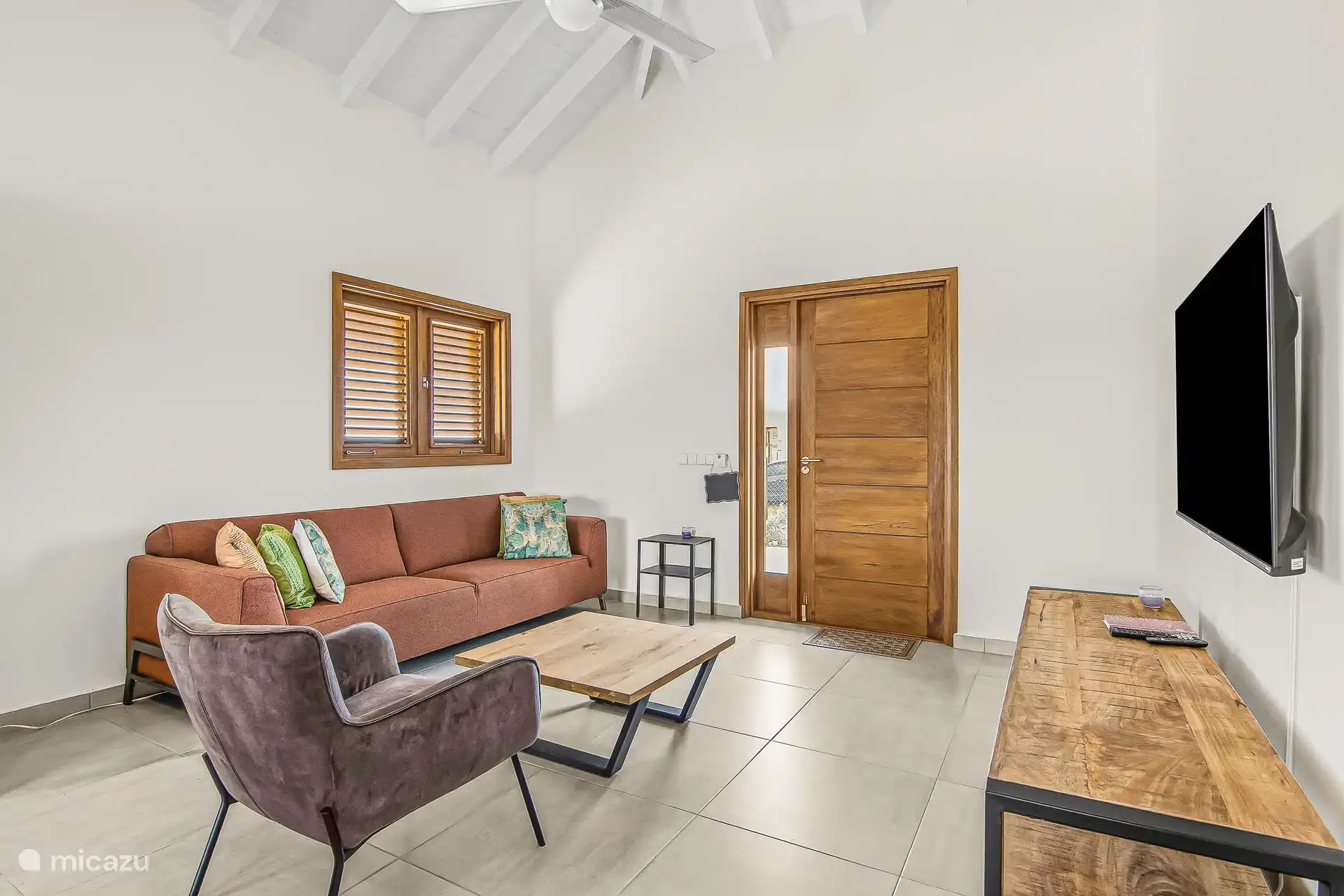 Spacious living room with nice sofa and chair. Smart TV