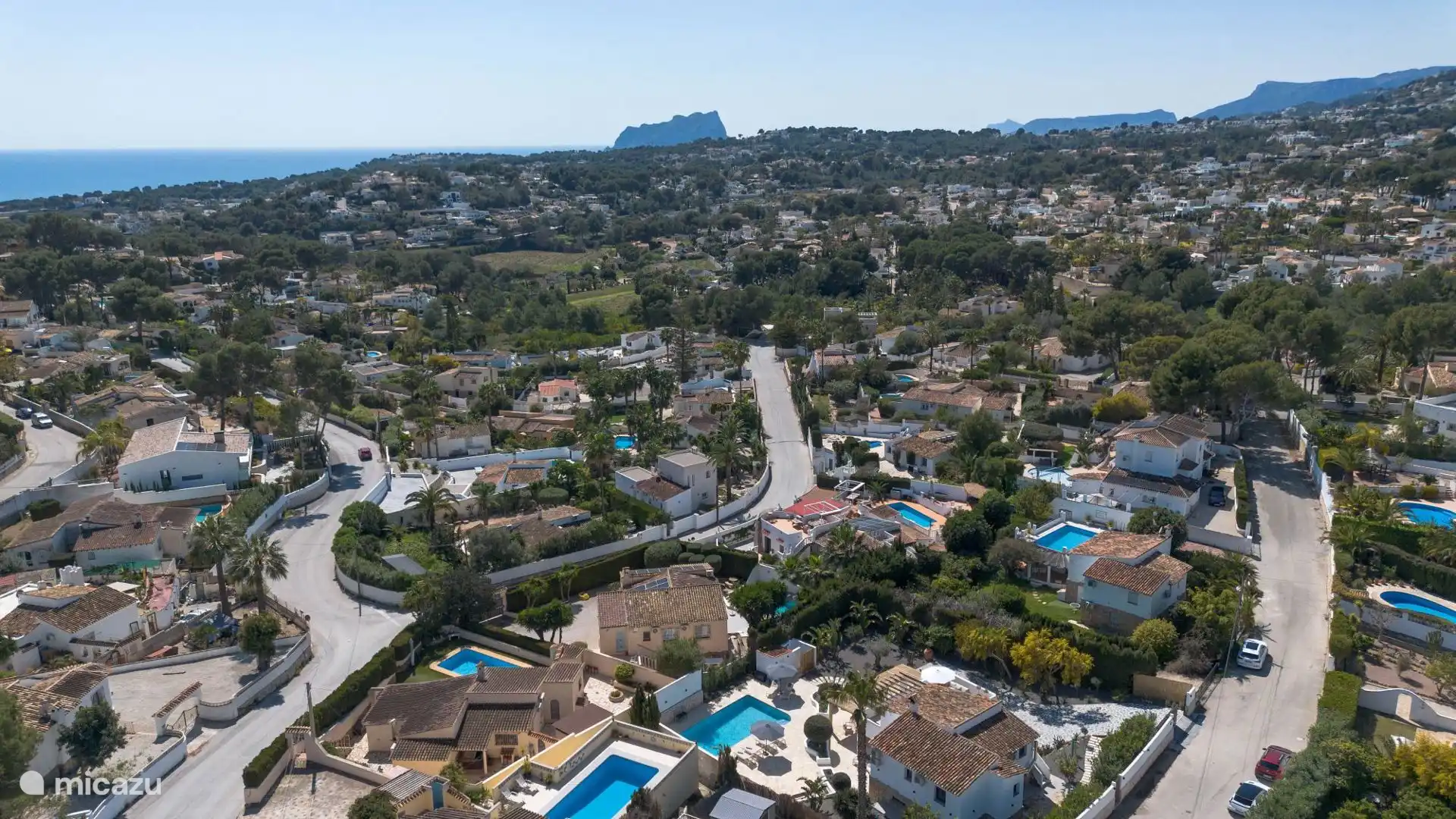 At the bottom in the middle of the house and distance to the beach