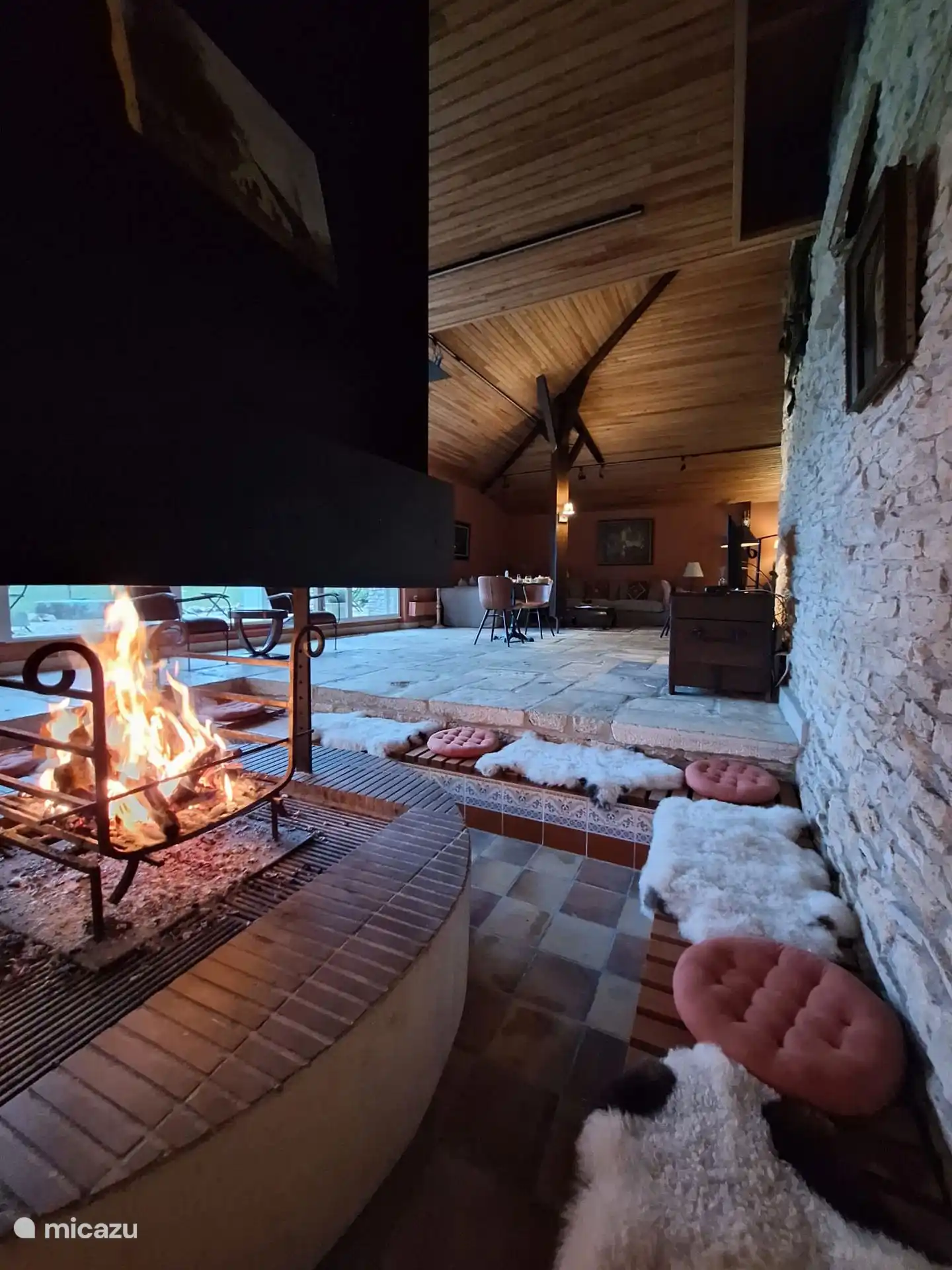 Beautiful large living space with large unique fireplace where you can sit around comfortably.