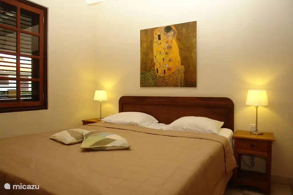 Master bedroom with air conditioning and fan, with private bathroom with sink, shower and toilet.