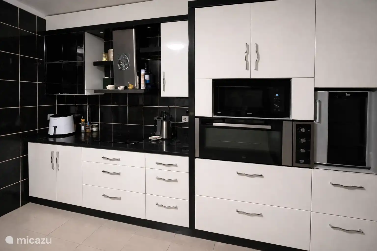 La cuisine avec une plaque à induction et d’autres appareils intégrés.