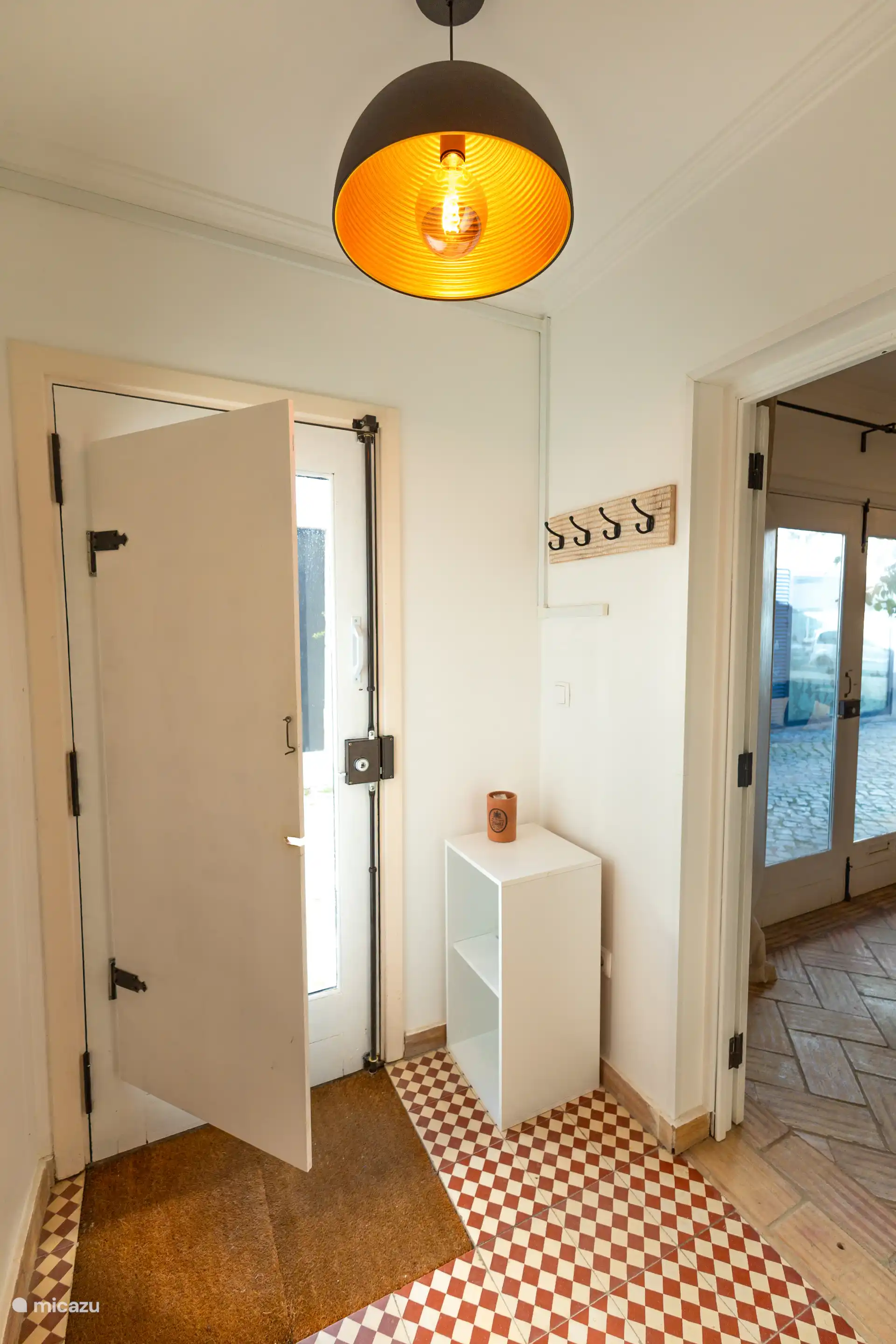 Entrance of the property with access to the downstairs bedroom (with door) and stairs towards the first floor