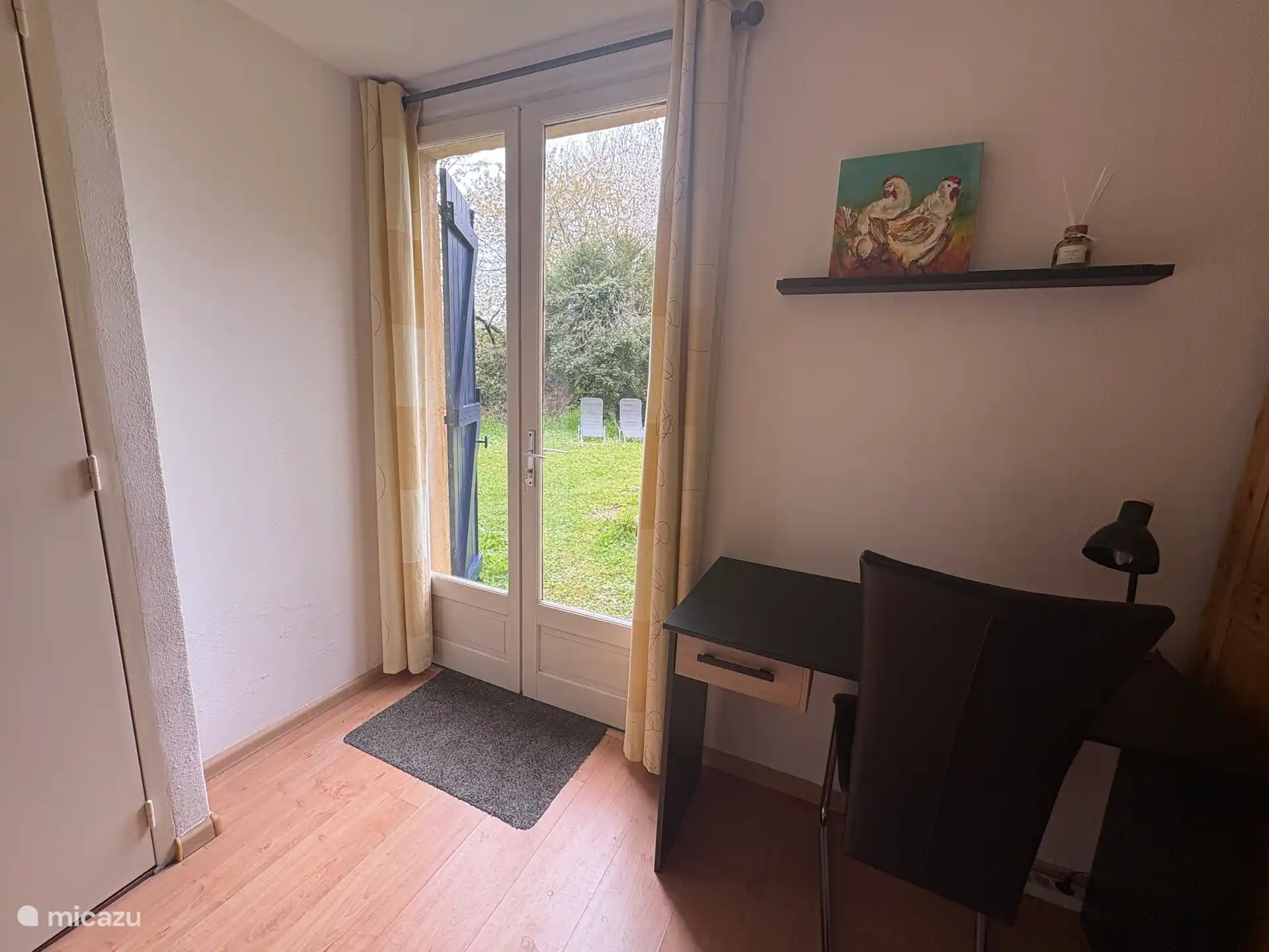 Bedroom 2 with desk and patio doors to the garden. On the left in the photos door to the bathroom ensuite.