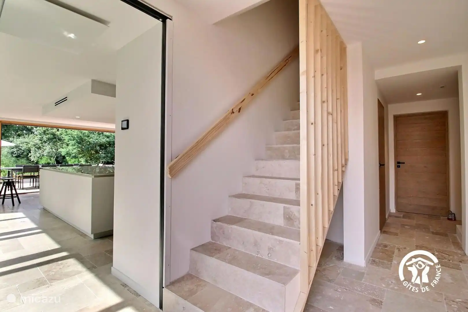 Escalier en pierres naturelles avec éclairage LED intégré dans la rampe, alliant élégance et modernité pour une montée sécurisée et mise en valeur.