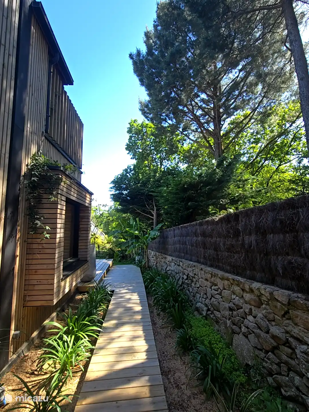 couloir entre chambre rdc et terrasses aménagements paysagers, offrant un environnement calme et naturel autour de la maison.