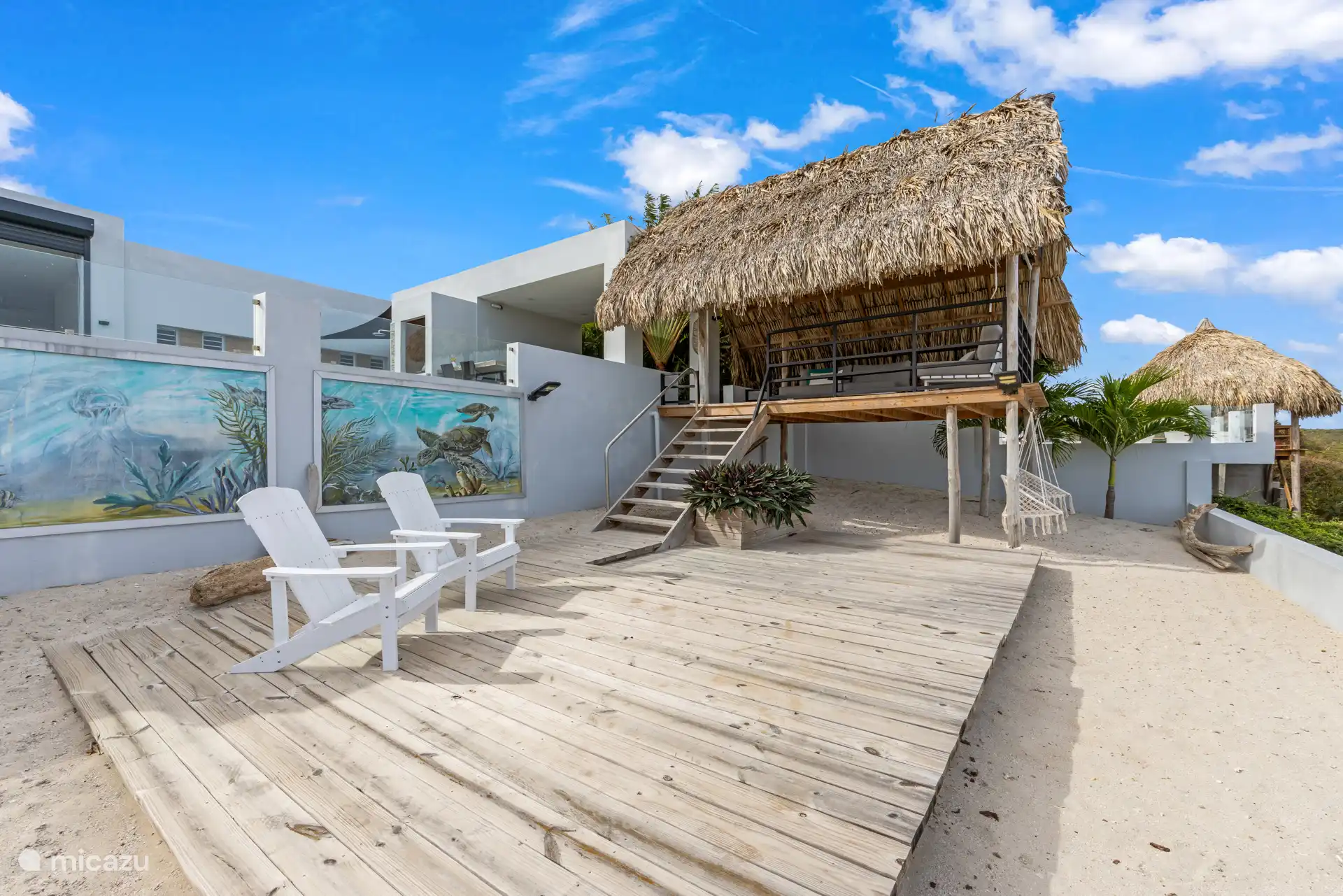 Een knus privéstrandje met relaxstoelen waar je in alle rust kunt genieten van het uitzicht en de mooiste zonsondergangen