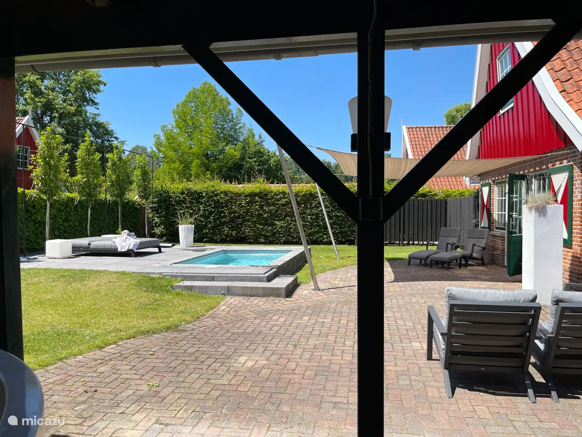 Uitzicht vanuit het overdekte terras over het zwembad