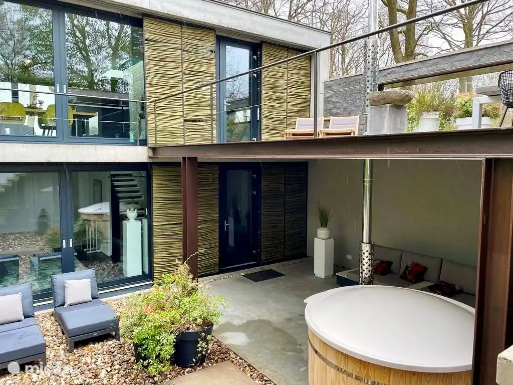 Outdoor terrace with lounge sofa, outdoor pool and hot tub