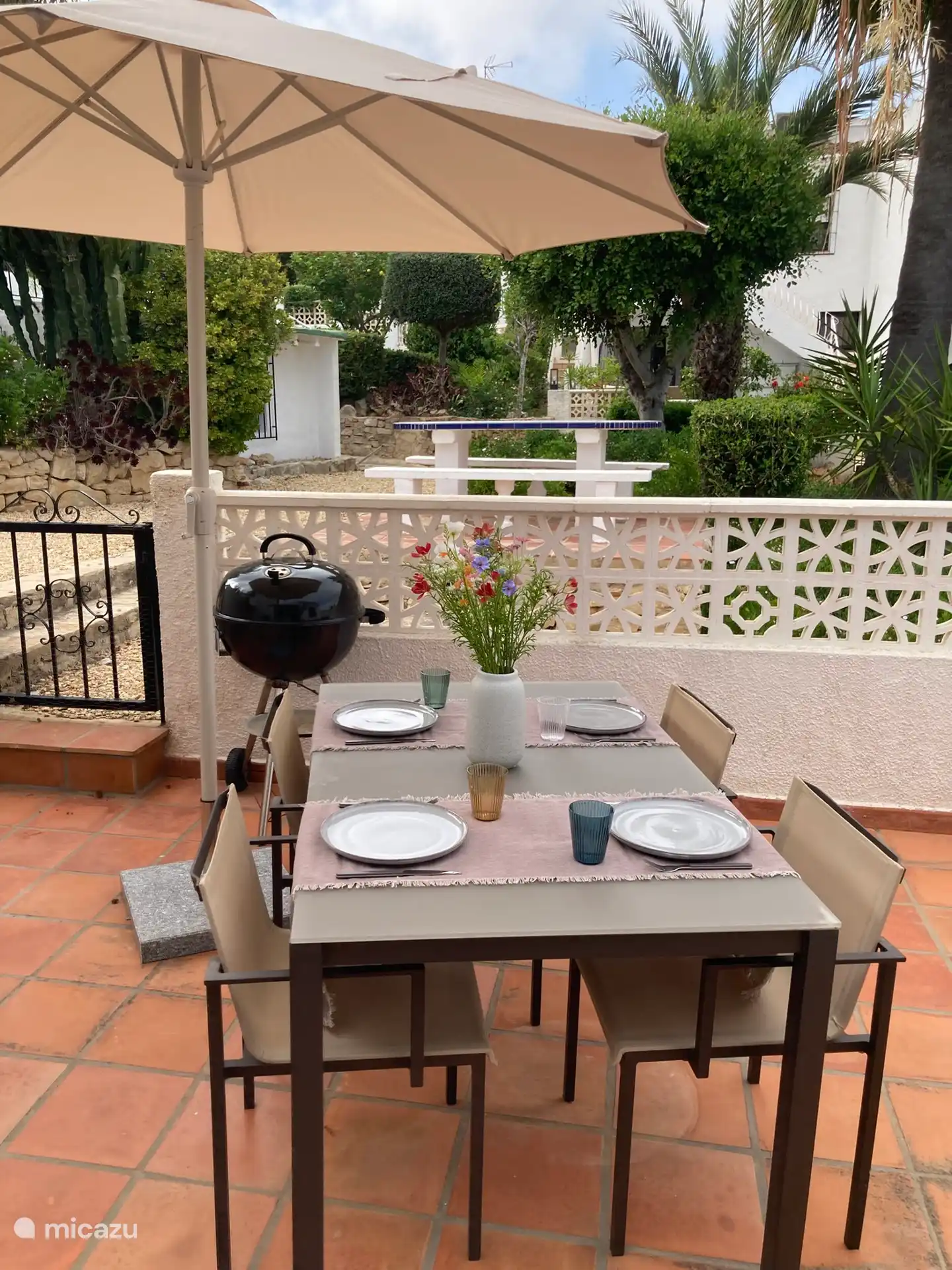 Cozy dining overlooking the beautiful garden, just a few steps from the pool.