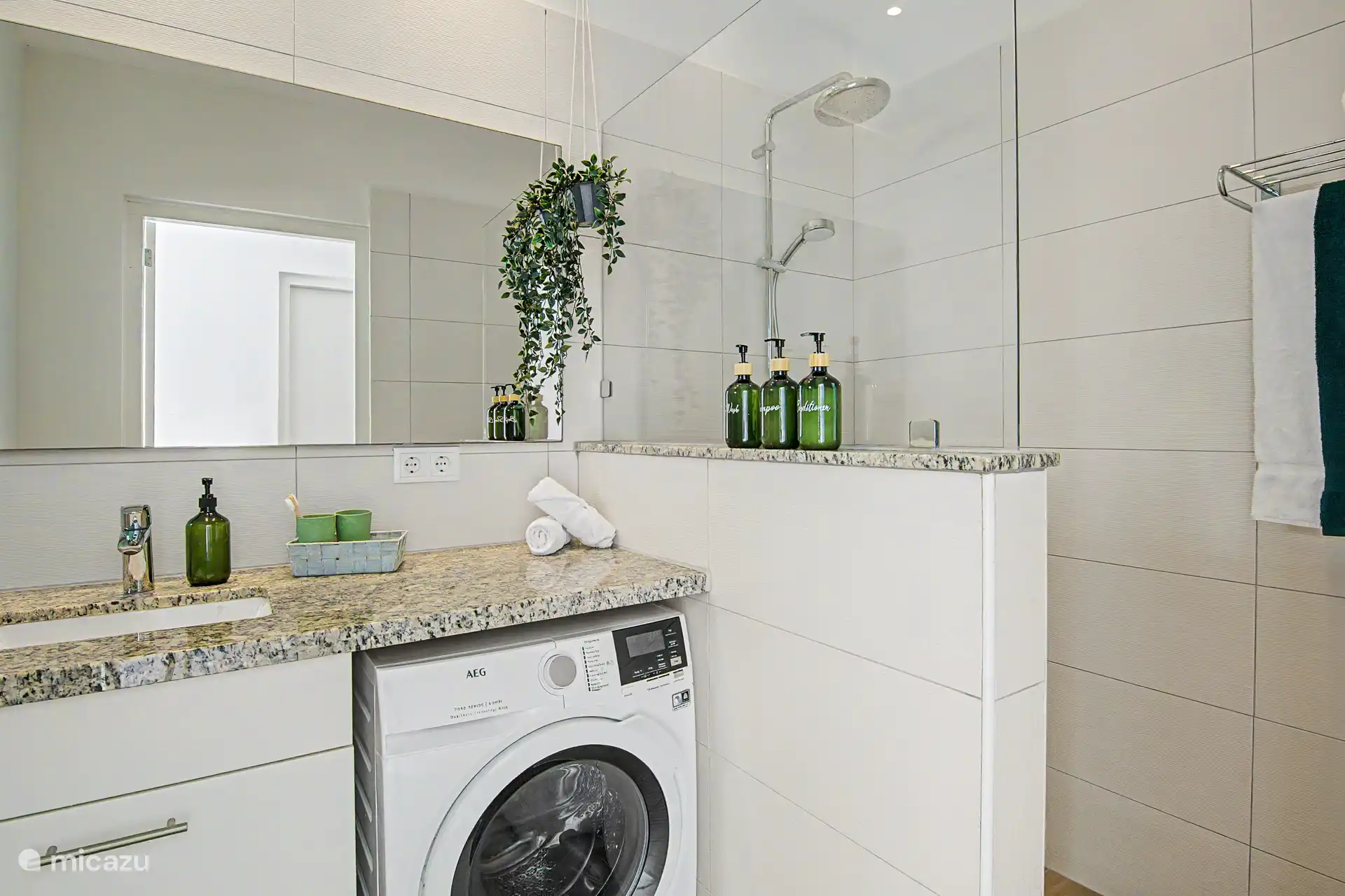 A spacious bathroom with amenities such as shampoo, conditioner and shower gel, washing machine and dryer and of course fine towels. 